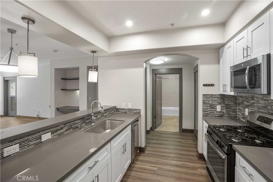 This beautifully maintained 2-bedroom, 2-bathroom condo offers comfort, convenience, and modern living in one of Valencia’s most sought-after communities. Step into a bright, open-concept living area filled with natural light—perfect for both everyday living and entertaining. The recently remodeled kitchen features contemporary appliances, ample cabinetry, and sleek countertops that elevate the entire space.
Both bedrooms provide tranquil retreats with generous closet space, while the bathrooms showcase modern finishes for a clean, updated feel. Enjoy your morning coffee or unwind in the evening on your private balcony, ideal for soaking in the Southern California weather.
Resort-style living is at your fingertips with a sparkling pool, outdoor BBQ area, well-equipped fitness center, clubhouse, and a dedicated community theatre room. Whether you’re relaxing, entertaining, or staying active, everything you want is within reach.
Located in a quiet, well-situated section of the building—away from common traffic areas—this unit offers added peace and privacy while still providing full access to community amenities. 
Within walking distance to multiple shopping centers, dining, retail, parks, and entertainment, this home delivers both lifestyle and convenience. Don’t miss your chance to claim this exceptional condo in a vibrant Valencia neighborhood. Schedule your tour today!