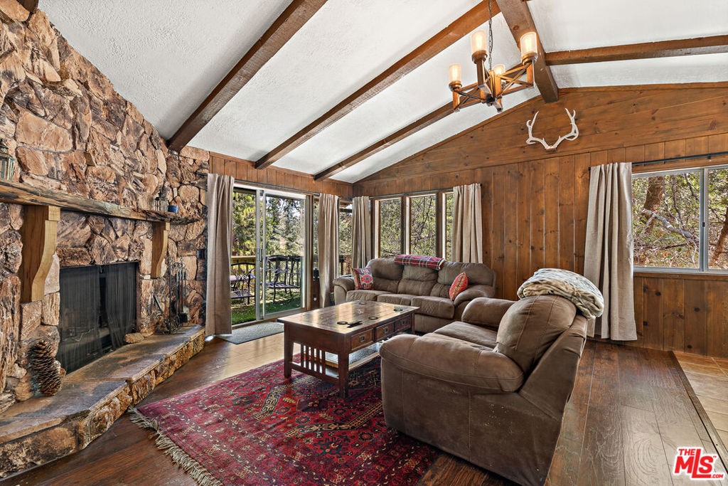 Escape to your own mountain hideaway in Running Springs! This 3-bed, 2-bath cabin blends cozy charm with modern upgrades, offering easy year-round access with level parking and entry. Just minutes from town yet surrounded by whispering pines, it's the perfect balance of convenience and seclusion. The main level welcomes you with a rustic rock fireplace as the focal point of the spacious living and dining areas, along with a bedroom, full bath, laundry, and a refreshed kitchen featuring energy-efficient appliances and new plumbing. Step out onto the expansive deck and take in unobstructed forest views that feel like your own private sanctuary. Downstairs, discover a roomy master suite with a private bath and a second bedroom with a large walk-in closet connected to additional storage space. The fully fenced yard includes a detached shed and plenty of room to breathe in that crisp mountain air. Close to hiking trails and Deep Creek's Narrows, this cabin is ready for full-time living or peaceful weekend escapes.