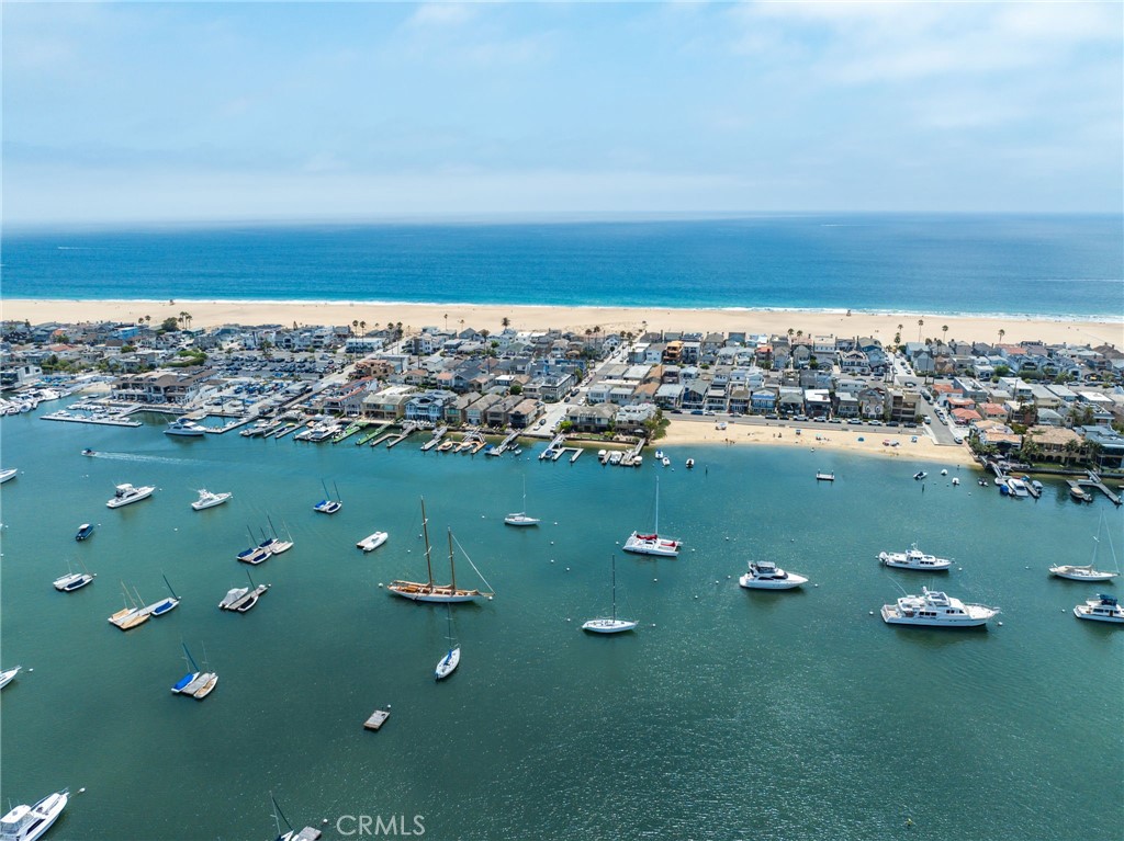 Discover your dream coastal retreat at 825 W Bay Avenue, Unit B, a newly constructed condo that elegantly merges luxury with comfort across 1,202 square feet of meticulously crafted living space. This exceptional home boasts 3 spacious bedrooms and 3 sophisticated bathrooms, making it perfect for both relaxation and entertainment, with breathtaking views from an expansive rooftop deck.
Step inside and experience the harmonious flow of hardwood floors, accentuated by the soft glow of chandeliers and recessed lighting. The open-concept kitchen is a chef’s paradise, featuring a sleek modern island, premium Thermador appliances, and a bespoke range hood, setting the stage for culinary creativity and dining enjoyment.
The living area is graced by a stunning Taj Mahal Quartzite fireplace, offering a warm and inviting atmosphere for gatherings. The second floor hosts the luxurious primary ensuite along with a secondary bedroom and bathroom, providing ample privacy and convenience. Venture to the third floor to discover a charming third bedroom and a 3/4 bath, perfectly complemented by a remarkable private roof deck with sweeping views of the beach, bay, and Newport Coast.
Immerse yourself in the coveted Newport Beach lifestyle with this exquisite condo, where every detail is designed for your ultimate comfort and style. Ideally situated next to a premier bay beach, perfect for soaking up the OC sun, 825 W Bay Unit B eagerly awaits to welcome you home.