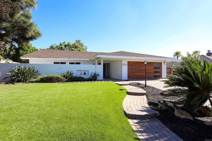 Recently updated single story home in the heart of Carlsbad! Situated on an oversized lot spanning almost 1/4 acre. New turf in the front yard. Modern garage door and newer exterior paint. A covered porch leads to your double front door entry. New vinyl floors throughout. No carpet! Charming brick fireplace in the living room and a large open living space - endless possibilities for furniture, lounging, play area and more. On the west side of the home, you have the kitchen which has been completely renovated with brand new soft close cabinetry, quartz countertops, a gorgeous tile backsplash, new dishwasher, new stove, and new light fixtures. The kitchen opens up to a sunny dining space with natural light beaming through the windows during the day. Dedicated laundry room with washer and dryer included. Epoxy floors in the garage with newer water heater. Attic storage with a stair pull down for easy accessibility. On the left side of the home, you have linen storage and cabinetry in your hallway, 2 sizable guest bedrooms and guest bathroom, and a large master suite. All bedrooms and the living room have newly installed ceiling fans. Updated bathroom fixtures. The property also has SOLAR! Huge savings on your power bill. Whole house fan for energy efficiency. Large flat backyard space - ideal for gardening, kids, and pets. Located just 15 minutes from the beaches and desirable attractions - Legoland, Flower Fields, The Village of Carlsbad. Top rated schools. Call today!