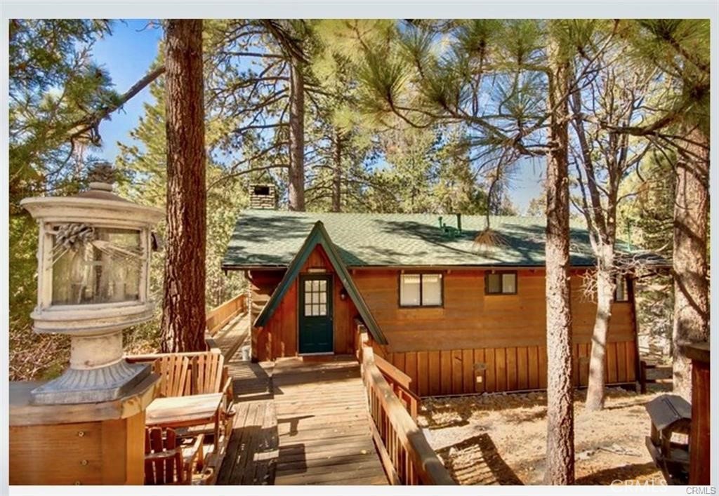 Tucked away in the peaceful lakeside community of Fawnskin, this charming 3-bedroom, 2-bath mountain home offers 1,475 square feet of cozy living space, perfect for both relaxation and adventure. The upstairs living room invites you to gather and unwind while enjoying the stunning views of the expansive 20,750-square-foot backyard from the deck. The kitchen, cute and quaint, is designed to complement the home’s warm, rustic charm. A separate office nook offers a quiet space for work or reading, while the lower-level family room, complete with a bar, is ideal for hosting after a day of hiking, boating, or skiing. The backyard features its own private sledding hill, providing endless outdoor fun right at home. Pride of ownership is evident in the tasteful mountain decor, creating a welcoming and comfortable atmosphere. Just a short walk to the lake and a few minutes’ drive to the charming town of Fawnskin, this property offers the perfect blend of tranquility and convenience. Embrace the mountain lifestyle and schedule your tour today!