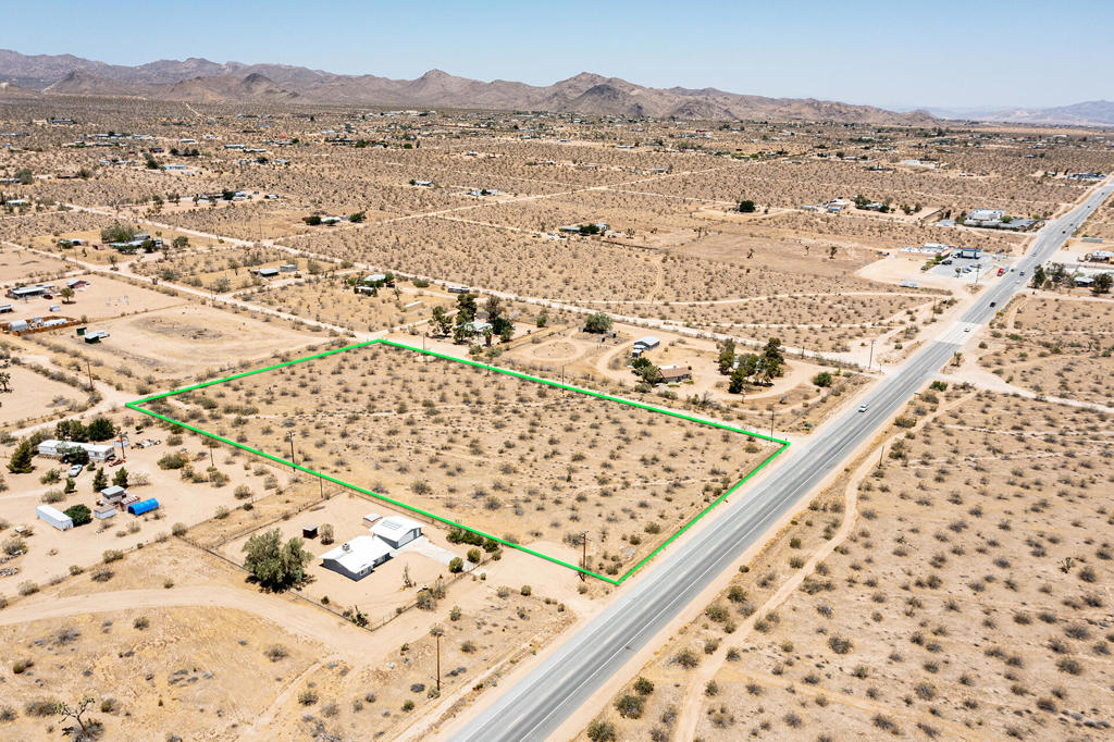 4.71 acres commercial/residential zoned land in trendy Flamingo Heights. Corner property with Hwy visibility. Power and water is right there. Commercial zoning may allow for a hotel, restaurant, strip mall, flea market, art gallery, bar, etc. The sky's the limit. Horse property and close to endless trails in the Sand to Snow Monument. Just down the way from the internationally known La Copine restaurant. Not far from the Giant Rock Meeting Room, Heroes Restaurant and 5 Dollar Pizza. A short drive to Pappy and Harriests world famous music venue. 19 miles to the Joshua Tree National Monument where about 3 million tourists visit annually. 23 miles to Johnson Valley where ''King of the Hammers'' ORV races bring 10s of thousands of spectators. 44 miles to Palm Springs. 130 miles to Los Angeles. Hot vacation area. Buyers must contact the county planners for all questions on building. Buyers must contact all the appropriate utilities agencies with all questions on utilities. GPS: 34.22815, -116.44079. S/E corner of Butte and Old Woman Springs Rd. Don't Wait! - Call Now! APN: 0629-421-07-0000 Address is real go direct. Lot size is approximate, buyer must investigate.