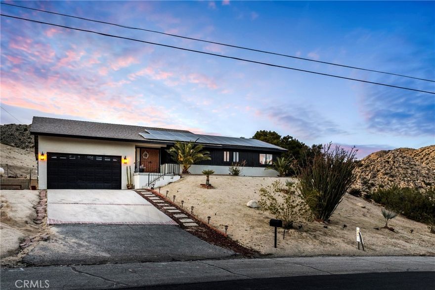 **PANORAMIC VIEW** FULLY FURNISHED & FULY PAID SOLAR PANELS** Welcome to “Casa Nopal”, your magical secluded retreat is situated on the upper part of the desireable County Club Estates and  tucked away in the foothills of Yucca Valley close to Joshua Tree & Pioneertown. This ranch style 3bd 2ba home features 2,812sqft and sits on a 1acre lot surrounded by mountains & the city below, with the most beautiful sunrises & sunsets. Some of the great features of this home includes a kitchen update less than three years old, with beautiful quartz counter tops, custom cabinetry, two electric range/ovens, perfect to prepare your favorite meals, and plenty of open space. There are three fireplaces in the home, one is located upon entry to the house in the elegant sunken seating area, the second one is located in the living room and the third fireplace is located in the primary suite as well as an outdoor fire pit. The primary suite features dual sinks/vanities with updated custom cabinetry, and an extra large walk-in closet. An addition to the other two bedrooms, there is a large second living/billiard room perfect for hosting and entertaining guest and enjoying a cocktail from your professional grade bar with surround system and LED lighting. The open yet private backyard is an entertainers dream with plenty of parking as well as for a large RV. The yard includes a custom patio & pergola, recently added in-ground pool with available heat, an outdoor firepit & propane flat grill, market lights for outdoor dining and plenty of open space for outdoor activities or just lounge in the sun. This home comes with FULLY PAID SOLAR PANELS, which will definitely help reduce your electricity bill.

This home is currently being used as an active AirBNB property and is fully equipped for an easy move in, the solar panels are fully paid which will help reduce your electricity bill. Casa Nopal is local to the Hawks Landing Golf Club, also the city of Yucca Valley has approved plans for a major aquatic and community center.