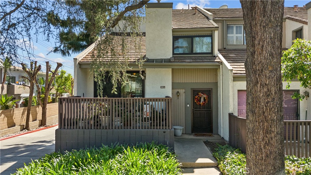 Beautiful end-unit townhome nestled in the serene and highly sought-after Fashion Park Villa community of Arcadia. This inviting residence offers a bright, open layout with soaring vaulted ceilings, large windows, and rich wood flooring that enhances the warm, welcoming atmosphere. The living and dining area features a cozy fireplace and opens to a private patio surrounded by mature trees—perfect for morning coffee or evening entertaining. The kitchen includes ample cabinetry, tile countertops, and a charming breakfast nook filled with natural light. The main floor also offers a bedroom and three-quarter bath, while the upstairs showcases a stunning remodeled primary suite. The upgraded ensuite bathroom exudes modern elegance, boasting quartz counters, a sleek frameless glass shower-tub enclosure, and custom cabinetry for extra storage. Additional highlights include a direct-access two-car garage, central HVAC, and access to the community’s lush park-like grounds with a heated pool and spa. Conveniently located near Westfield Santa Anita, the L.A. County Arboretum, Arcadia County Park, and award-winning Arcadia schools, this home perfectly blends comfort, charm, and everyday convenience in one of the city’s most desirable neighborhoods.
