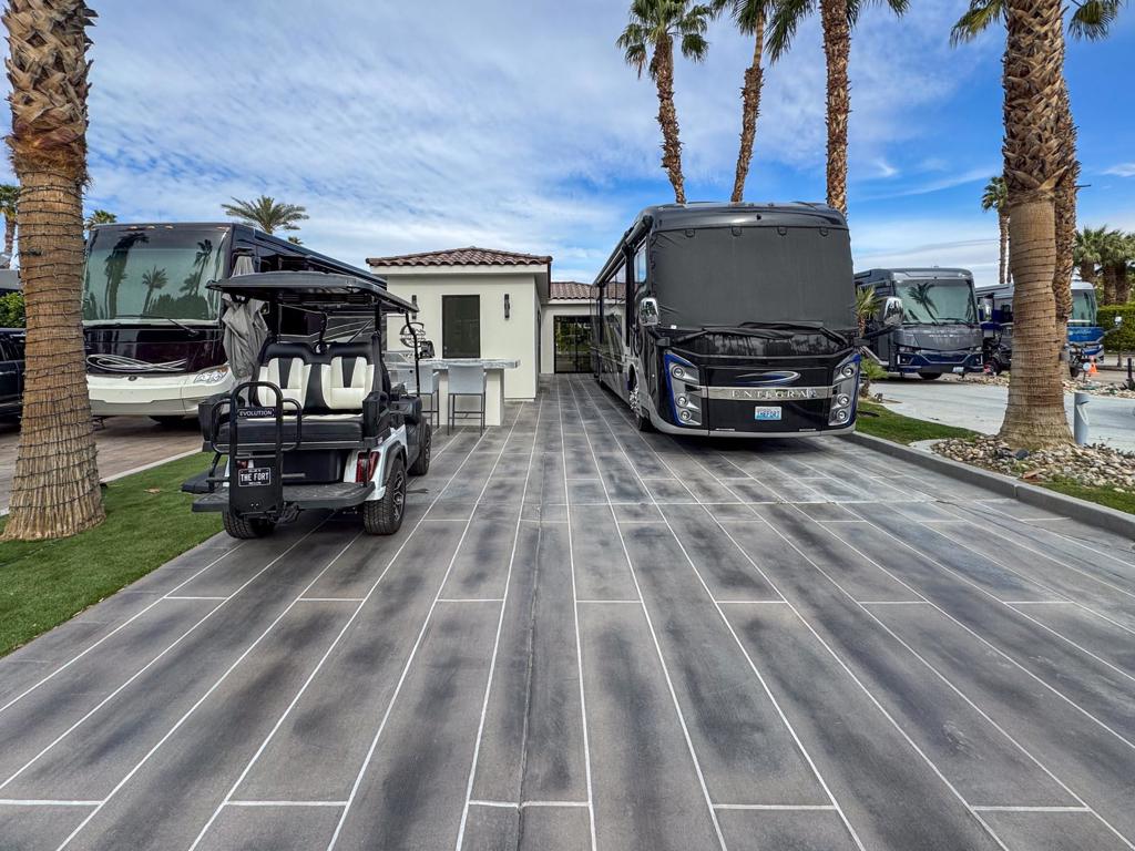 Nestled on a spacious lot, this stunning 705 sq. ft. modern casita seamlessly blends indoor and outdoor living with three expansive glass walls, flooding the space with natural light and allowing optimal air circulation. Soaring 10- and 12-foot ceilings enhance the open feel, while a custom plank wood ceiling in the living room and high-end finishes add a touch of refined elegance. The full-size kitchen features quartz waterfall countertops, a full-size fridge, a stylish tile backsplash, and tall custom cabinetry with glass inserts, maximizing both beauty and storage. A cozy fireplace and a state-of-the-art entertainment center set against a floor-to-ceiling tiled wall create a sophisticated and inviting ambiance. Ceiling fans and a climate-controlled splitter ensure absolute comfort, while the epoxy-covered RV pad and angled lot improve drainage. Astro turf and additional exterior lighting further enhance the curb appeal.The spa-inspired bathroom boasts full-height tile, dual sinks, dual shower heads, and dual medicine cabinets, while a large hot water tank ensures uninterrupted comfort. A full laundry setup adds convenience. Outside, an expansive pavered back porch offers ample space to enjoy breathtaking golf course views, while the front wrap-around quartz bar, complete with a pop-up TV, BBQ, and fridges, provides the ultimate setting for entertaining (TV not included). Thoughtful additions like a post-covering screen and custom bar covers enhance privacy and sophistication. Whether you're unwinding indoors or hosting guests outdoors, this exceptional RV lot delivers an unparalleled luxury lifestyle. Furniture is negotiable.‍Outdoor Resort Indio is a Class A only RV resort in Indio, CA.