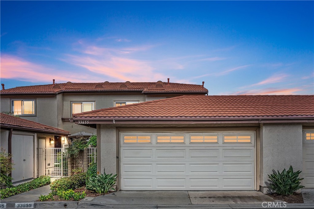 Discover this beautifully updated 3-bedroom, 2.5-bathroom home in the highly sought-after Seaside Villas Community, just a 10-minute stroll to Doheny State Park Beach and Dana Point Harbor. This move-in-ready residence features brand-new luxury vinyl plank flooring, brand-new carpet, recessed lighting, and sophisticated light fixtures throughout. Plantation shutters and a cozy white brick fireplace complement the freshly painted interior. The kitchen offers generous counter space and cabinetry, seamlessly connecting to the dining area and private patio for outdoor dining. Upstairs, the spacious primary suite boasts vaulted ceilings, mirrored closet doors, and an updated en-suite bathroom with dual vanities and modern fixtures, while two additional bedrooms and a second updated bathroom provide ample space. Further highlights include an indoor laundry room, a guest powder room, and an attached two-car garage just steps from the front door. Residents enjoy two sparkling pools (one heated year-round), two relaxing jacuzzis, a clubhouse, and direct access to Sycamore Creek Trail, perfect for walking or biking to the beach. Located near Dana Point Harbor, scenic trails, restaurants, and shopping, this home offers the quintessential Southern California coastal lifestyle.