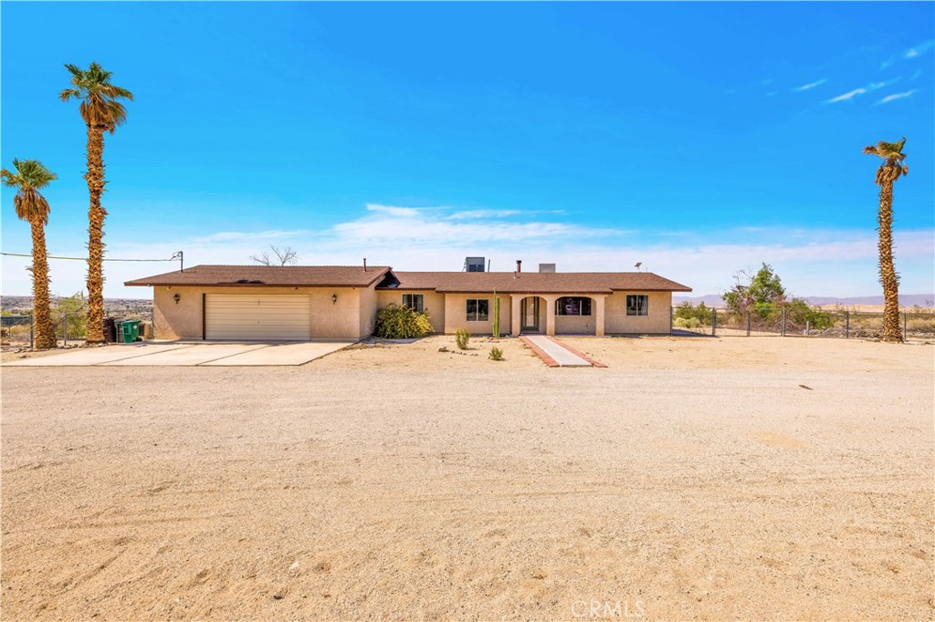 Situated on a massive 2.7 acres with over 1800 SQ foot house AND a 700 SQ foot garage/living space and additional enclosed back patio with ample windows and sliders that create a great extra large room for playing and enjoying the vast view! This amazing home is built slightly elevated on a slight incline so you have views all day long and are right near the entrance to the base of the Joshua Tree National Park entrance and less than a mile from the casino and 29 palms restaurants, bars and shops! It s a true gem in the desert! Not a fixer but it can use your special touch to make it yours!
Open floor concept with living room and a dining room and kitchen all connected. There is a den off the main living space that could be closed off for more privacy or just used as is. So much potential to remodel this to your particular liking. Master bedroom is large and can fit a King bed as well as additional seating. Large oversized, updated walk-in shower for the master bedroom. Two additional rooms and a full bath for them to share. One bedroom is attached to the garage as a pass through and can also be closed or kept as is. New Swamp cooler. Older AC unit still works, but aged. Great breeze when doors are open. The garage could fit three cars! Used as a large living room for the current owners which add an additional 700 sq feet to the home when used this way. Truly an amazing home, that is move-in ready with some painting and minor updating if preferred. Come and see what you could do to make this your next home or investment property!
(There is an additional structure that has power to it, that has been utilized as an artist studio. Buyers to do their own due diligence on all permitting and inspections independently.)
