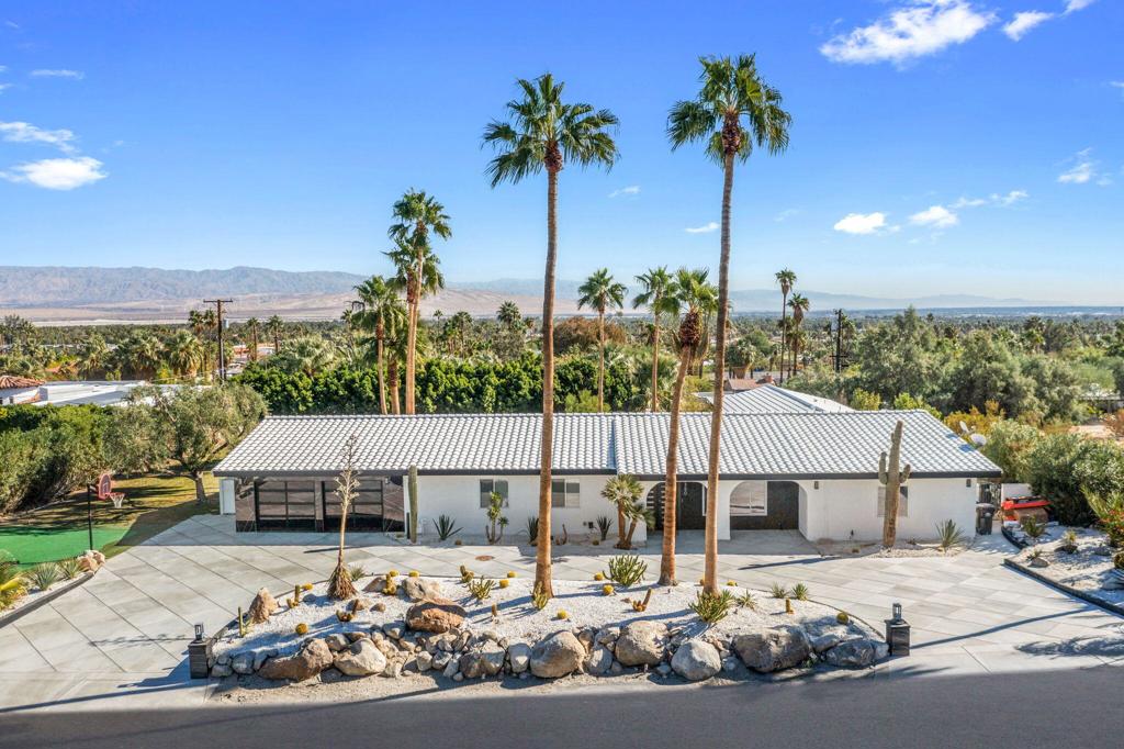 Discover this beautifully remodeled, turnkey 5-bedroom, 4-bathroom pool home available for seasonal rental in the desirable NO HOA community of Chino Canyon / Little Tuscany. Fully furnished and ready for immediate enjoyment, this home is perfect for large parties or luxurious getaways, featuring dual primary suites on opposite sides of the residence and two additional guest bedrooms. Step inside to soaring vaulted ceilings, recessed lighting, and dramatic floor-to-ceiling stone accent walls that exude warmth and sophistication. The open layout includes a stylish dining area, large but cozy living room with an electric fireplace, and a generously sized dry bar, all set on blond oak flooring. The contemporary kitchen shines with stone countertops, custom cabinetry, and a designer range hood. Both primary suites offer private patio access, perfect for poolside relaxation with stunning city and mountain views. Spa-inspired bathrooms feature stone walls, modern vanities, fog-free mirrors, walk-in showers, and no-touch toilets for a truly indulgent retreat. The expansive estate sized grounds offer heavenly views of Mt San Jacinto, as the Coachella valley stretches out before you. Enjoy a custom pool and spa, outdoor shower, expansive grassy area, elevated dining space, basketball, and a private putting green--ideal for entertaining or unwinding. Book your stay today!