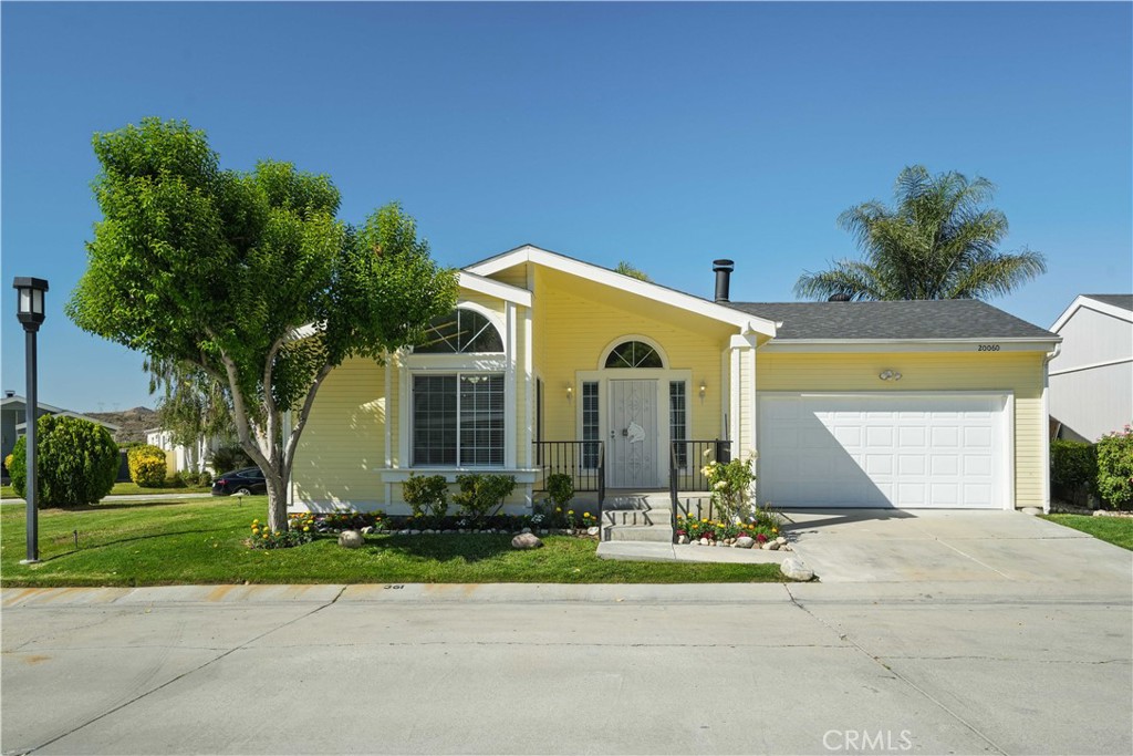 Beautifully upgraded 3-bedroom, 2-bath home located in the desirable Canyon View Estates, offering both privacy and modern updates. Positioned next to a corner lot with only one neighbor, this home features fresh interior and exterior paint, brand-new luxury vinyl plank flooring, and new carpet in the bedrooms. The open layout includes a spacious living area with a cozy fireplace, and a bright kitchen with a built-in desk, ample cabinetry, and a convenient bar-top for casual dining. Ceiling fans are installed throughout the home for year-round comfort. The primary suite is a true retreat with separate dual vanities, a soaking tub, a walk-in shower, and a large closet. A sliding door from the primary bedroom provides easy access to the covered patio and grassy backyard, ideal for relaxing or entertaining. Located within Canyon View Estates, the home carries a monthly land lease of $1,649.09, which includes access to community amenities such as two pools and spa, sport courts, playgrounds, 24-hour gated security, clubhouse, and RV storage. Conveniently close to shopping, dining, schools, parks, and commuter routes. Don’t miss the opportunity to own this updated, move-in ready home in a quiet and friendly community. Please submit pre-approval and proof of funds with your offer. Buyer to verify all information prior to close of escrow.