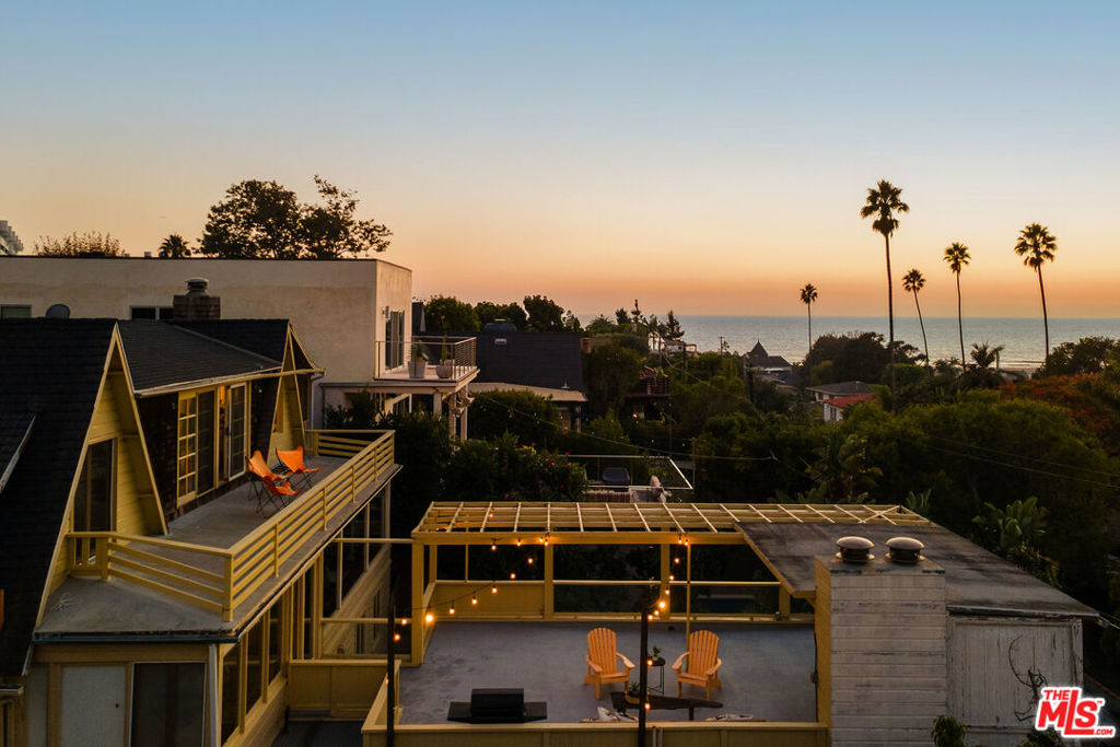 Nestled in the highly sought after Santa Monica Canyon, 237 Mabery Road offers the rare combination of privacy, vintage charm, and stunning ocean views - all just moments from the beach. This storybook cottage features two separate structures: the main residence and a bonus structure that can serve as a guest house, private office, or provide income potential! The main home welcomes you with a wall of windows across the living and dining areas, framing lush canyon views and filling the interior with natural light. Wood-beamed ceilings, a stone fireplace, and a spacious sundeck blend classic 1930s craftsmanship with effortless indoor outdoor living. Upstairs, the primary suite enjoys panoramic views of the ocean and canyon, a private balcony, and adjacent flex space perfect for a den, office, or reading nook. Two additional bedrooms with vaulted ceilings and diamond lattice windows complete the upper level, exuding warmth and architectural character throughout. The main level also includes a bedroom and full bathroom, ideal for guests or easy single level living. The second structure offers a bright one bedroom guest home with floor to ceiling windows that capture serene canyon views. Below, a separate studio with private patio provides additional space for guests, work, or wellness. This home offers the ultimate coastal lifestyle, located on one of the Canyon's most desirable streets and within walking distance to the award-winning Canyon Elementary School and some of the neighborhoods best restaurants including Giorgio Baldi, The Golden Bull, and Caffe Delfini.