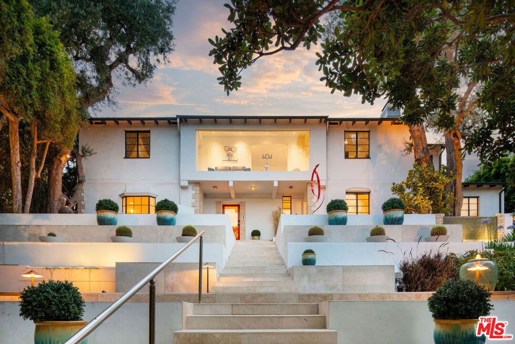 An extraordinary opportunity to lease a trophy estate overlooking the Los Angeles Country Club. This six-bedroom, seven-bath architectural residence offers a seamless blend of elegance, privacy, and modern comfort, available furnished or unfurnished for terms of one year or longer. Set behind gates and lush hedges, the home welcomes you with calming water features, curated landscaping, and multiple intimate seating areas, perfect for enjoying the serene gardens and uninterrupted views of verdant fairways, the glittering city skyline, and the Santa Monica Mountains beyond. The formal entry leads to a grand living room, anchored by a striking fireplace, which flows effortlessly into a chef's kitchen appointed with professional-grade stainless steel appliances. Designed for both entertaining and relaxation, the residence boasts a state-of-the-art screening room with seven-speaker surround sound and luxury seating for six, ideal for private industry screenings or family movie nights. Outdoors, mature landscaping and cascading fountains create a resort-like setting. Expansive patios with automated awnings invite alfresco dining and effortless entertaining. The primary suite is a true retreat, with a spa-inspired ensuite bath, a bespoke walk-in closet, and breathtaking golf course views. Generously scaled guest suites, two private offices, a flexible bonus room, a sunroom with dramatic vistas, and a second-floor laundry room complete the living spaces. Additional features include a finished three-car garage with ample storage, as well as convenient guest parking. Located just moments from Beverly Hills, Westwood, and Century City, and within the coveted Fairburn Avenue Elementary school district, this property offers a rare combination of exclusivity, convenience, and lifestyle.