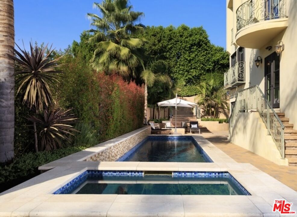 Perched atop a secluded, gated street off Benedict Canyon Drive, this breathtaking Mediterranean estate offers an unparalleled fusion of privacy, sophistication, and panoramic vistas stretching across the canyon and city skyline.Built in 2004, this five-bedroom, seven-bathroom villa spans 4,874 sq. ft. on an expansive 61,393 sq. ft. lot, capturing mesmerizing sunrise-to-sunset views that flood the home with natural light. Offered fully furnished or unfurnished, the estate showcases bespoke designer pieces and exquisite craftsmanship, featuring soaring ceilings, polished stone floors, and custom elements curated by renowned designers, including Cowtan & Tout, Colefax & Fowler, Coraggio, and Zimmer Rohde.Two exquisite Murano crystal chandeliersone evoking ocean waves and the other a cascading golden leafadd an artistic touch to the home's refined aesthetic. Every window and terrace frames sweeping, unobstructed views of lush hillsides and glittering city lights, creating an ambiance of serene grandeur.The open-concept layout flows seamlessly from a grand formal living room with a custom fireplace to a dining area perfect for entertaining. The gourmet chef's kitchen boasts top-tier stainless steel appliances, an oversized island, granite countertops, and a spacious walk-in pantry.The fully remodeled primary suite is a private retreat, complete with cherry hardwood floors, an oversized custom closet, and a spa-inspired bath featuring a steam shower and Japanese soaking tubeach space designed to maximize the breathtaking scenery. Floor-to-ceiling Dupioni silk drapes in the master suite add a rich, luxurious elegance, enhancing the tranquil atmosphere.Three additional en-suite bedrooms offer lavish comfort, while a private office, gym, and media room elevate the home's lifestyle appeal. The resort-style backyard is an entertainer's paradise, featuring a non-chlorine ionized lap pool, spa, fire pit, BBQ, and an outdoor kitchen all set against a backdrop of dramatic canyon and cityscape views.A temperature-controlled 1,200-bottle wine cellar, smart home automation, and a two-car garage with additional gated parking for four more vehicles ensure effortless luxury. Located just minutes from Rodeo Drive's world-class shopping and dining, this estate is a sanctuary of elegance, offering unparalleled views, designer upgrades, and ultimate tranquility. Also for Sale $6,250,000