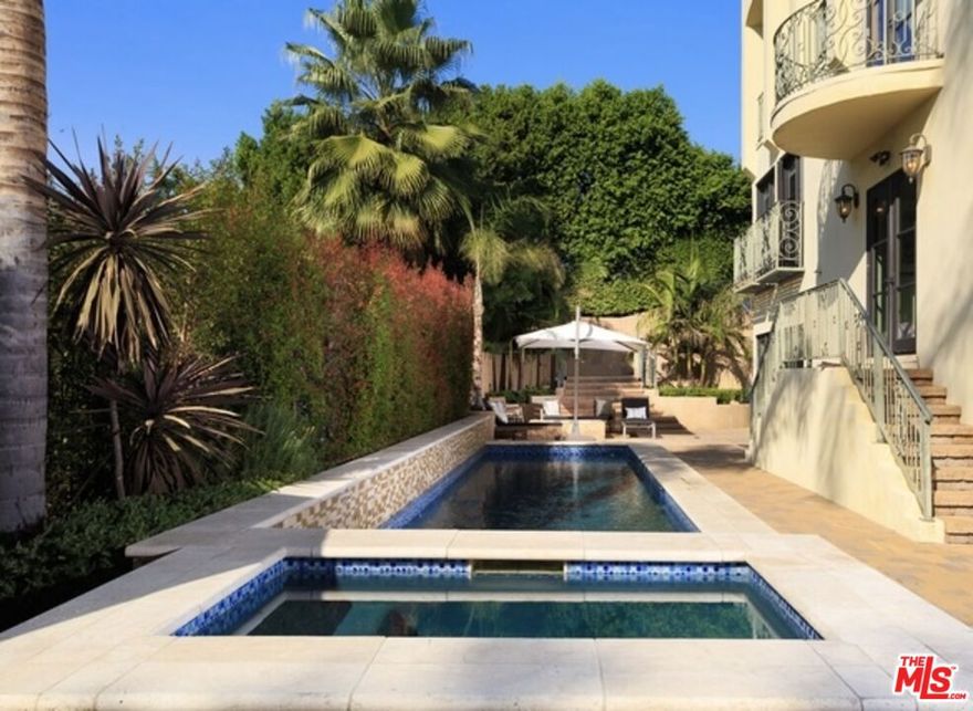 Perched atop a secluded, gated street off Benedict Canyon Drive, this breathtaking Mediterranean estate offers an unparalleled fusion of privacy, sophistication, and panoramic vistas stretching across the canyon and city skyline.Built in 2004, this five-bedroom, seven-bathroom villa spans 4,874 sq. ft. on an expansive 61,393 sq. ft. lot, capturing mesmerizing sunrise-to-sunset views that flood the home with natural light. Offered fully furnished or unfurnished, the estate showcases bespoke designer pieces and exquisite craftsmanship, featuring soaring ceilings, polished stone floors, and custom elements curated by renowned designers, including Cowtan & Tout, Colefax & Fowler, Coraggio, and Zimmer Rohde.Two exquisite Murano crystal chandeliersone evoking ocean waves and the other a cascading golden leafadd an artistic touch to the home's refined aesthetic. Every window and terrace frames sweeping, unobstructed views of lush hillsides and glittering city lights, creating an ambiance of serene grandeur.The open-concept layout flows seamlessly from a grand formal living room with a custom fireplace to a dining area perfect for entertaining. The gourmet chef's kitchen boasts top-tier stainless steel appliances, an oversized island, granite countertops, and a spacious walk-in pantry.The fully remodeled primary suite is a private retreat, complete with cherry hardwood floors, an oversized custom closet, and a spa-inspired bath featuring a steam shower and Japanese soaking tubeach space designed to maximize the breathtaking scenery. Floor-to-ceiling Dupioni silk drapes in the master suite add a rich, luxurious elegance, enhancing the tranquil atmosphere.Three additional en-suite bedrooms offer lavish comfort, while a private office, gym, and media room elevate the home's lifestyle appeal. The resort-style backyard is an entertainer's paradise, featuring a non-chlorine ionized lap pool, spa, fire pit, BBQ, and an outdoor kitchen all set against a backdrop of dramatic canyon and cityscape views.A temperature-controlled 1,200-bottle wine cellar, smart home automation, and a two-car garage with additional gated parking for four more vehicles ensure effortless luxury. Located just minutes from Rodeo Drive's world-class shopping and dining, this estate is a sanctuary of elegance, offering unparalleled views, designer upgrades, and ultimate tranquility. Also for Sale $6,250,000