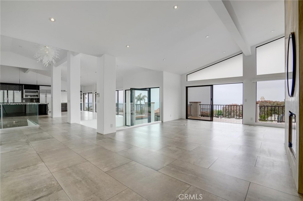 Experience unparalleled luxury and breathtaking panoramic views of the Pacific Ocean from this meticulously remodeled single-level home, complete with a three-car garage beneath that is newly listed for lease. This exquisite property boasts a world-class kitchen outfitted with top luxury brand appliances, perfect for culinary enthusiasts. Every detail of the home has been thoughtfully upgraded to combine elegance with comfort, ensuring a sophisticated living experience. The spacious living room, featuring a cozy fireplace, opens onto a large ocean-view balcony, seamlessly connecting to the formal dining room, the eat-in kitchen, and the master suite. This balcony provides an idyllic setting for enjoying stunning sunsets and the serene beauty of the ocean. The home offers four additional bedrooms, one of which is currently utilized as a den, along with a convenient laundry room that leads to the expansive rear yard. The large, paneled family room, complete with a wet bar, also opens to the backyard, making it an ideal space for entertaining. The backyard is a haven for outdoor living, featuring a sparkling pool, a relaxing spa, and ample grassy areas for recreation and relaxation. Located in the highly sought-after upper Lunada Bay area of Palos Verdes Estates, this home promises both luxury and tranquility in a prime coastal setting.