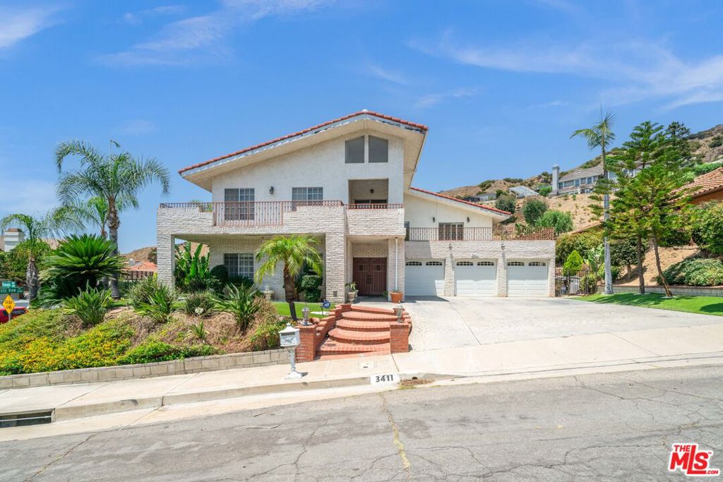 Perched on a prime corner lot of nearly 24,000 sqft in the coveted Burbank Hills, this estate-sized property presents a rare opportunity to restore and reimagine a true classic.Offering 4,821 sqft of living space, this expansive home features 5 bedrooms and 5 bathrooms, including a desirable first-floor suite with its own private bath, ideal for guests or multi-generational living. Upstairs, you'll find the spacious primary suite with a cozy sitting room, along with three additional bedrooms, one of which is also an en-suite, plus an entertainment room that opens to a large terrace with sweeping views and refreshing breezes.The home's thoughtful layout includes a sunroom for year-round enjoyment and an inviting pool and spa, perfect for creating your own private oasis. While the property may benefit from some TLC, it boasts solid bones, enormous potential, and a lot size that's increasingly rare in today's market.A 3-car garage and expansive yard offer ample room to customize, whether you're dreaming of lush landscaping or an outdoor kitchen.This is more than just a home, it's a canvas for your vision, nestled in one of Burbank's most sought-after enclaves. Bring your imagination, your contractor, and your dreams. Opportunities like this don't come around often.