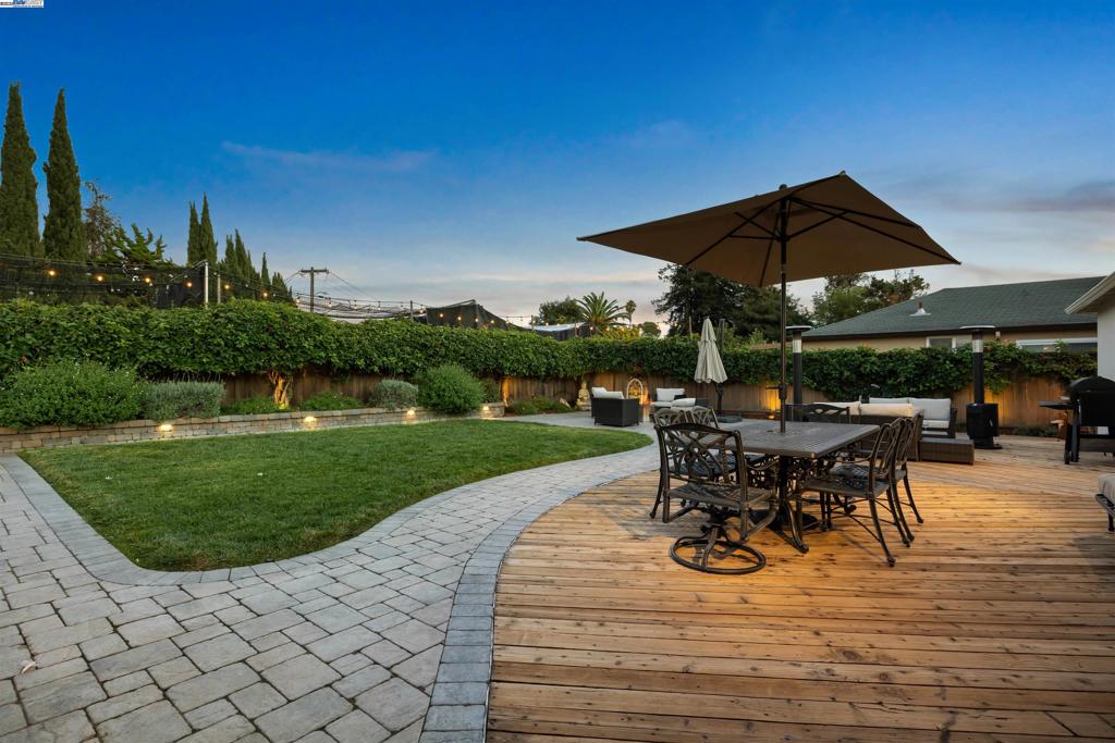 Charm, comfort & community come together here in sought after Washington Manor! Fresh exterior paint, a wide driveway & lush lawn create standout curb appeal, offering a warm welcome into a home created for comfort & entertaining. Framed by a large dual-paned picture window & patio slider, the living area captures light & showcases beautifully maintained floors, bountiful space & exquisite decor. The kitchen featuring a touchless faucet & new SS refrigerator. A true backyard retreat awaits: an entertainer's paradise w/a large deck adorned by solar ambiance lighting, paver & wood patios, stone wall accents, manicured planters & lush landscaping. Thoughtful upgrades include electrical outlets, drip irrigation, French drain & a wide side yard finished w/colorful pea gravel. Enjoy the bounty from apricot & plum trees and raised edible garden beds! An oversized garage w/finished attic loft, plus a 2nd interior attic w/flooring, lighting & pull-down ladder access. An outdoor shed provides even more storage flexibility. Enjoy classic neighborhood favorites like Porky's Pizza, Clancy's Ice Cream & Mama Lupe's, with Washington Manor Park & Aquatic Center just blocks away. Commuters will appreciate easy access to major freeways, BART and Oakland Airport. Live, laugh & love — here!