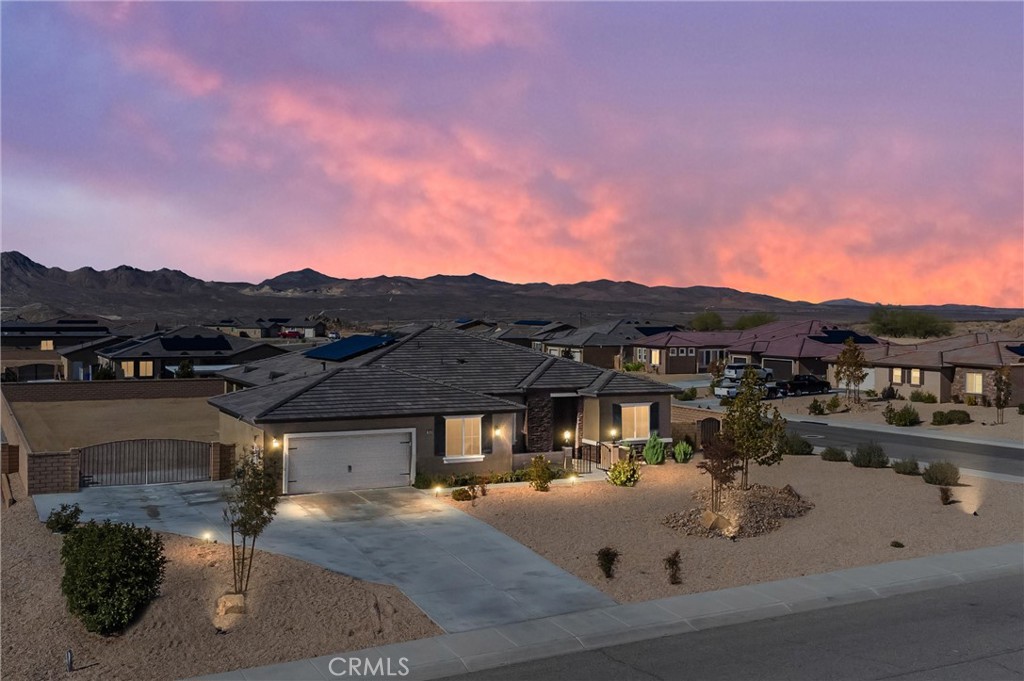 Resort Living at its' finest! This stunning home is located in the popular Vista Del Sol Estates "gated" community. Close to shopping, restaurants, freeway access and entertainment. Welcome to your new High Desert Oasis, this light and bright open floor plan offers a grand living area with gourmet kitchen, four generous sized bedrooms, three baths and an office. Enjoy a spacious open indoor/outdoor space with French doors off the kitchen that open to a large patio accented with a breathtaking fireplace. Find yourself in an open setting to entertain family and friends while the fireplace blazes with warmth and the natural light floods in through the French doors. You'll stay extra cozy while sipping your favorite glass of wine while watching the sunset. Whether you're reading a book, enjoying a cup of coffee or watching a movie, you'll enjoy the expansive feel of the living room entertainment area. Built with sustainability in mind, it is re-imagined with design from high end finishes to elevated ceilings. Step away from reality and escape to your cozy master bedroom retreat. This separate wing offers privacy for the master bedroom and a sprawling bathroom that offers a soaking tub, walk-in shower, large master closet and has its own private entrance from the backyard patio. You will find two large bedrooms in a separate wing, both thoughtfully designed with lots of natural light. Designed with premium windows in each, wake up to the feeling of being nestled with views of distant mountains. The fourth bedroom is located off the kitchen wing and offers a walk-in closet. This majestic residence is located on a large corner lot. Plenty of room to create your own park-like setting, fully fenced to corral all the furry family members and kiddos who will enjoy hours of fun to run and play. RV parking and plenty of room to store your boat. Oversized garage to store all your toys. Separate laundry room and tankless water heater. You will experience peace and restoration throughout this thoughtfully designed and meticulously maintained home.