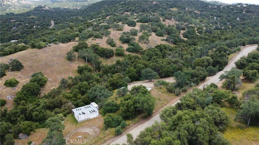 Welcome to this beautiful 5+-acre parcel of rolling foothill land, featuring a steel structure, well and plenty of level area ideal for your dream home or getaway. The property includes a private water well and a seasonal creek, enhancing its natural appeal. Mature oak trees and natural trails invite exploration.
Enjoy the potential for great privacy with multiple access routes to the property. Conveniently located within 10 minutes of the Country Store, and within an hour of national parks and major shopping, this land offers the perfect balance of seclusion and accessibility. Don't miss your chance to make this gem your own!