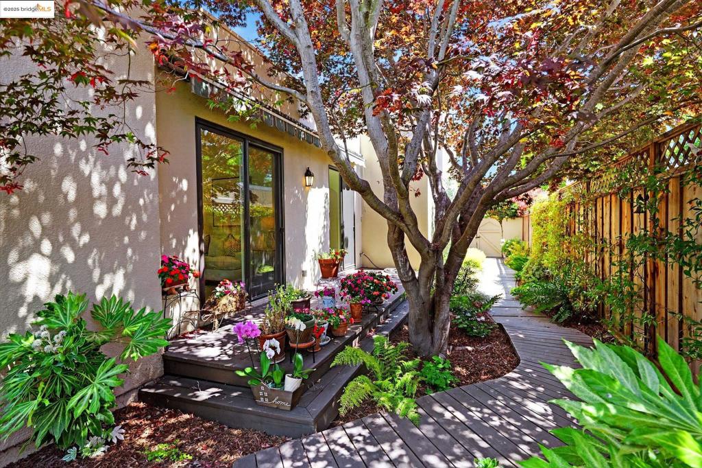 ALAMEDA SECRET GARDEN ESCAPE. Unlatch the arched gate and peek inside... wow! Contemporary Spanish architecture showcases a grand living room with a fireplace, formal dining room, two bedrooms, a bathroom, a den and a kitchen so spectacular it was featured in Alameda Magazine! Enjoy light-filled spaces, skylights, gleaming floors and thoughtful design at every turn. Upstairs is your private penthouse suite with built-in shelving, a lounge area with a fireplace, a walk-in closet, a remodeled bathroom and a sliding door that leads to your private rooftop deck. The home is surrounded by lush gardens where you can enjoy serene vignettes and find a favorite spot to read and relax. Nearby you can stroll in the public park or play a game of pickleball at the courts. Restaurants and shops are on nearby Park Street as are highly rated schools and all that Alameda has to offer. No expense was spared for this lovingly maintained home. Live your best Alameda life!