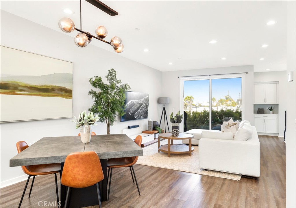 Welcome to 1523 Sullivan Avenue, where modern coastal living meets the best of Costa Mesa. This 2-bedroom, 3.5-bathroom end-unit condo spans 1,961 sq. ft with a perfect balance of elevated design and beach-close convenience. Step inside to discover a versatile first-floor flex space with a full bathroom, ideal for a home office, gym, or guest suite. Upstairs, the open-concept living space is bathed in natural light, featuring wide-plank flooring, bespoke lighting, and a designer kitchen with open shelving, quartz counters, walk-in pantry, and stainless appliances. The dining area flows seamlessly into the spacious living room and out to a private balcony, perfect for morning coffee or evening grilling. The third level is dedicated to two bedrooms, laundry and ample storage. The primary suite is a calming retreat with a spa-like bathroom featuring dual sinks and modern finishes. The crown jewel is the expansive rooftop deck, ideal for entertaining, with room for lounge seating, dining, and taking in panoramic views of city lights, mountains, and even a peek of the Pacific on a clear day. Additional highlights include an attached two-car garage and laundry on the bedroom level. All of this is set just blocks from the popular restaurants, cafés, and shops along 17th Street and minutes from Newport’s beaches, parks, and easy freeway access. This Sullivan Avenue stunner combines effortless style, flexible living spaces, and a location that puts the best of Costa Mesa and Newport Beach right at your door.
