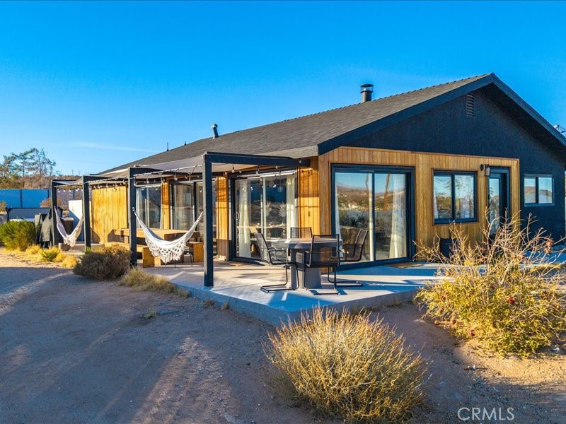 Welcome to Polaris Ranch! A fully gated, beautiful 2.5 acre horse property only 5 minutes from Downtown Joshua Tree, the property is close enough to all that Joshua Tree has to offer and far enough to provide you with the tranquility you seek in the desert. This designer gem offers a wide open floor plan with plenty of natural light, and with a living space that is perfect for entertaining. The living room features a hand troweled TV/entertainment wall upon which sits a wood burning fireplace to cuddle up by during the cool desert nights. The new modern kitchen will make any chef feel right at home and comes with all top rated appliances included. 3 spacious bedrooms, one of which connects to the en-suite bathroom that features double vanity sinks and a luxurious floor-to-ceiling tiled walk in shower. The other opens up to an al fresco secluded shower and soaking tub.a The fully re-designed exterior features a yurt, hammocks, cowboy pool and jetted jacuzzi. Also boasting Brazilian wood clad walls, a reed covered sun shade under which you can relax, and a courtyard that connects the main house to the workshop/shed that can be used for entertaining, an outdoor living space or your very own horse barn. (Note: Property consists of 2 lots that may have the ability to be split.)