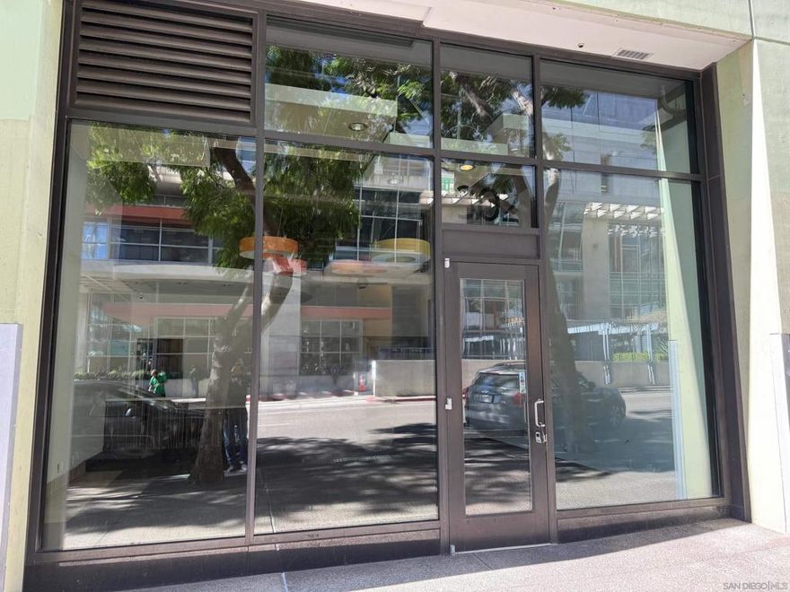 RETAIL STOREFRONT in the popular Icon Condominium Bldg. This vacant retail store front commercial condominium is located in the Petco Park area of East Village.  Steps to Petco Park, home of the San Diego Padres with restaurants, coffee shops, microbrewery pubs and many residential condos and apartments in the neighborhood, this retail store front condo offers several business use opportunities, from a professional business, law firm, insurance company, dry cleaner pick-up and many other business uses.  This could have tenant set up with base rent with NNN's to have tenant pick up many of the expenses related to the commercial condo.  Space includes floor-to-ceiling glass storefront, decorative drop lighting and can lights. Space has a built-in private bathroom, small office, storage room and additional upstairs storage.