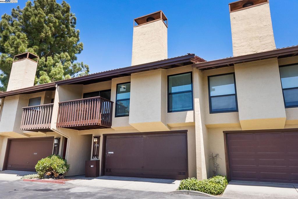 Price Improvement – Incredible Value! Welcome to this spacious and beautifully updated 2-bedroom, 2-bath townhouse tucked away in a quiet cul-de-sac, surrounded by mature trees and lush, park-like grounds that create a truly serene setting. The home features an open floor plan with vaulted ceilings, exposed beams, and abundant natural light. Enjoy modern upgrades including stainless steel appliances, new cabinets, and updated flooring throughout. Step out onto a private deck from the living room—perfect for relaxing or entertaining. Additional highlights include a newer HVAC system and water heater, a 2-car garage, and access to resort-style community amenities including a pool and clubhouse. Conveniently located near major transportation, shopping, and freeway access, this home offers a rare blend of comfort, style, and a uniquely tranquil atmosphere.