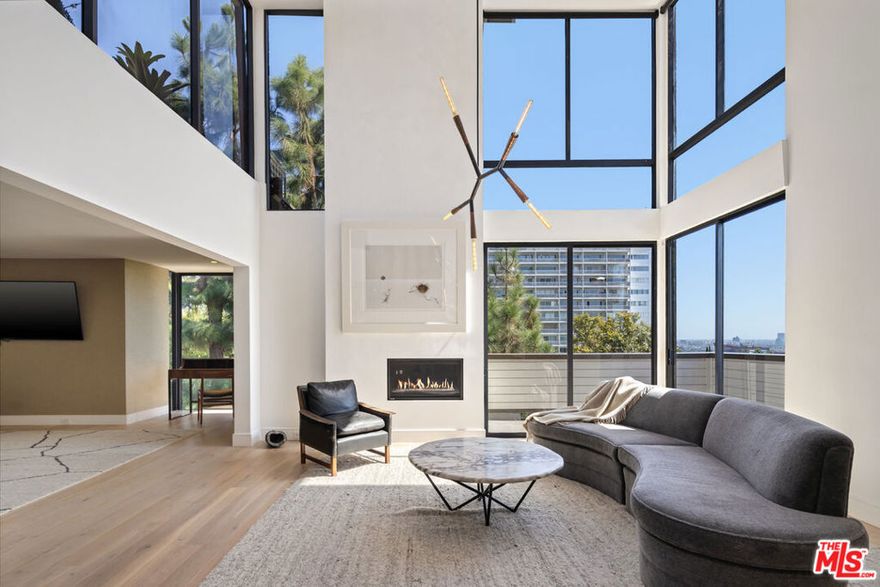 Set within The Carolwood Condominiums-an award-winning Ron Goldman, FAIA design-this rare Penthouse combines architectural significance with contemporary luxury. One of only two south-facing units and the largest in the complex, it offers city-ocean views and includes a private 600 sq ft rooftop terrace overlooking Beverly Hills. Interiors feature soaring 16th-ft ceiling (living room), floor to ceiling windows, and French oak floors. The open plan flows through a dramatic living room, den and office into a marble-clad designer kitchen with Sub-Zero, Miele and Wolf appliances. The primary suite includes a custom walk-in closet and spa-like marble bath with heated floors and Waterworks fixtures. 2nd bedroom on the ground floor includes an additional slab marble bath with Waterworks fixtures . Resort-style amenities-pool, spa and gym-complete this exceptional residence, moments from Soho, Bird St, Boa, The Edition and West Hollywood's most iconic destinations.  This Penthouse is one of a kind and rarely comes on the market.