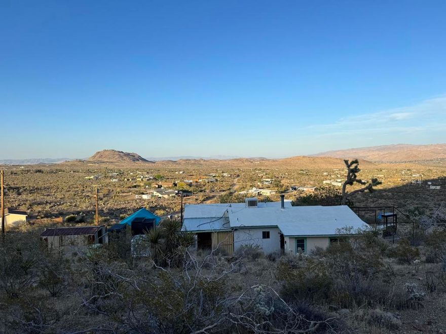 Vintage hill side retreat with Panoramic Desert views on 5 acres. Is connected to city water and electric. Escape to timeless serenity in this rare 1950's home perched high up on the hillside. Step inside and be transported back to a simpler era- Original character throughout with solid construction. Whether you are looking to preserve its vintage soul or infuse it with modern design, this canvas awaits you. Should qualify FHA submit offers now