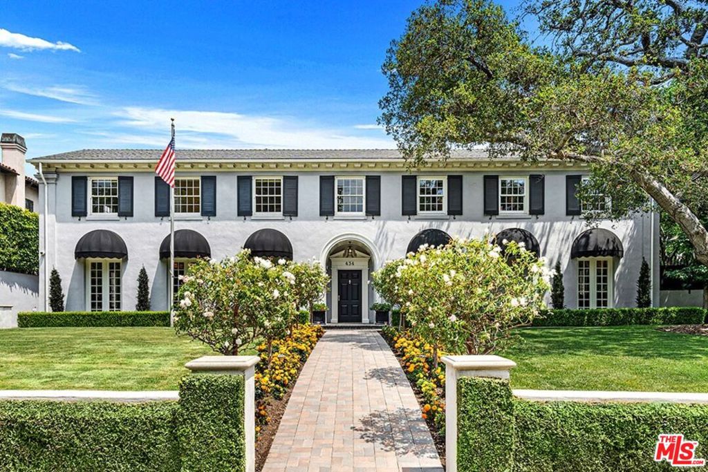 Introducing the stately Colonial Revival renowned for festive celebrations. A distinguished Hancock Park residence, celebrated for hosting unforgettable Halloween & Holiday events, combines grandeur with casual elegance. Opportunities abound for both relaxation & entertainment. The expansive backyard offers a paradise for outdoor fun, featuring a sparkling pool complete with a slide, diving board, custom ground-level trampoline & zipline!! A sixty+ foot rooftop deck provides a sensational bird's eye view of the charming neighborhood. Enter the elegant foyer revealing the lavish 1920s craftsmanship throughout the property. A generous living room with stunning marble fireplace, built-ins & three exposures create a pleasant light-filled environment. An intimate office, also with fireplace, adjoins the living room & accesses the covered patio. The grand scale formal dining room accommodates all occasions. Enter the exquisitely redesigned gourmet kitchen with center island and sweet eat-in breakfast area with an adjacent breakfast room. Sensational screening/family room boasts a bar, and French door access to the yard, ensuring seamless indoor-outdoor living. A bedroom, bath & powder complete the 1st floor. The 2nd floor includes 4 generous ensuite bedrooms including the primary suite with fireplace, an atrium ideal for reading & enjoying rainy days, and a large office for those who work from home or seek a private retreat. Ample storage throughout. A handsome guest house with bath is situated above the three-bay garage, offering privacy and comfort for visitors. Located within blocks of Marlborough School & Larchmont Village. Write the next chapter in its storied history!