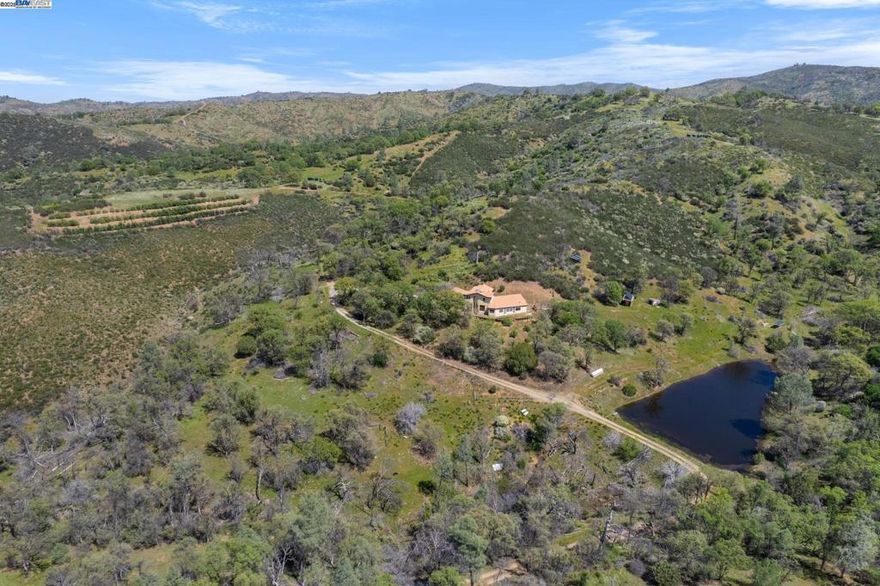 210-Acre Off-Grid Ranch with Olive Orchard & Custom Home Discover peaceful, sustainable living on this private 210-acre ranch just off Mines Road. Thoughtfully subdivided into three parcels (each with deeded access), this off-grid property offers self-sufficient living powered by solar, wind, and generators, with a shared well supplying all parcels. The custom home, built in 1996, sits on Parcel 2 and offers a simple, functional layout. Warmth comes from propane and pellet stoves, and while there’s no traditional A/C, cool hilltop breezes and nightly ventilation keep the home comfortable. A highlight of the property is the established olive orchard—about 100 Arbequina trees—complete with its own solar-powered well and irrigation system. There is a mill room with an olive mill from Italy where great quality olive oil is made. Nature lovers will appreciate the abundant wildlife, two ponds, and stunning starry skies free from city lights. Whether you're seeking a peaceful retreat, a working ranch, or a unique off-grid lifestyle, this property offers endless possibilities. Located 40 minutes from Livermore