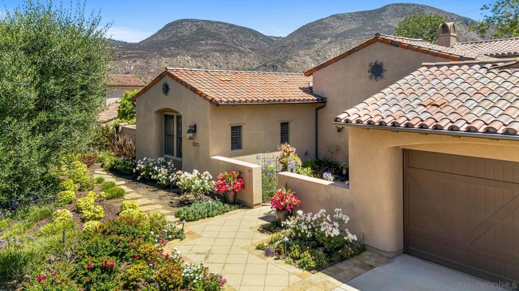Single-Level Living in The Crosby of Rancho Santa Fe. Pride of ownership is evident from the moment you arrive at this beautifully maintained estate, tucked away on a quiet cul-de-sac in the guard-gated community of Crosby, a premier golf course community in Rancho Santa Fe. Designed around a stunning center courtyard, this home lives like a single level, with the added bonus of a second-story loft that includes a full bedroom and bathroom. The inviting floor plan is filled with natural light and is ideal for indoor-outdoor living. The spacious great room and chef’s kitchen open directly to the courtyard, creating a seamless flow for entertaining. The main level features a private primary suite with garden views and exceptional privacy, along with two additional ensuite bedrooms and a formal dining room. The upstairs loft, complete with its own bedroom and den, is perfect for guests or extended stays. Major improvements include newer HVAC systems, a Sub-Zero refrigerator, dishwasher, Twin Eagle 42-inch BBQ with side burners, and a newer water heater, to name just a few of the thoughtful upgrades. Additional highlights include a wireless security system, distressed hardwood floors, a 3-car garage, mature fruit trees, meticulous landscaping, and a lush hillside backdrop that offers both peace and seclusion. Enjoy the beauty of nature, quiet surroundings, and a strong sense of community, all just moments from world-class golf and amenities at The Crosby Club. The Crosby golf club offers an incredible array of amenities and social activities including an 18 hole golf course, the club house, a driving range, world class sports center, swimming pool/spa, pickle ball and tennis courts. Different levels of memberships are available and *required* for use of the community amenities featured in this listing