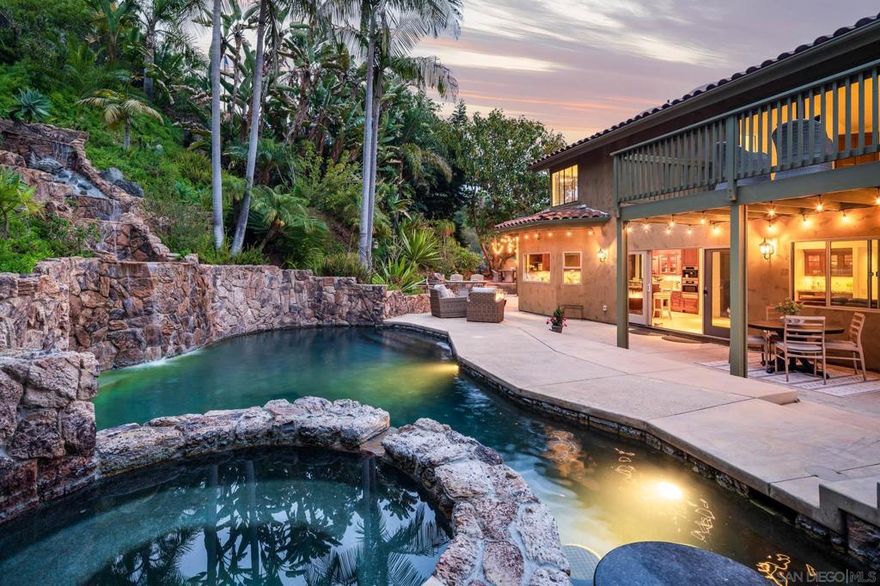Tucked away at the end of a quiet cul-de-sac in Cardiff, this beautiful 4-bedroom, 3-bath home sits on an oversized pie-shaped lot with a tropical backyard oasis. The lava rock pool and spa feature a built-in table and chairs, complemented by a cozy fire-pit. A custom addition offers soaring ceilings and pocket doors for seamless indoor-outdoor living. Enjoy surround sound throughout the home, a chef’s kitchen with African mahogany, top-tier appliances, and built-in cherry cutting board. With a master retreat, paid solar, 3-car garage, and just a mile to the beach—this home is a must see!