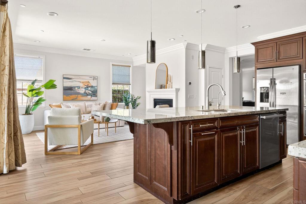 7001 Via Agave is a true stand out in Pacific Highlands Ranch! This stunning 5BR/4.5BA residence offers an open, light-filled floor plan with soaring ceilings and thoughtful updates throughout. Step inside to find freshly painted interiors, upgraded counters in both the kitchen and bathrooms, and stylish new bathroom mirrors that elevate the modern feel. The chef’s kitchen is equipped with premium appliances, including a Miele dishwasher, and flows seamlessly into the spacious family room with a cozy fireplace perfect for both entertaining and everyday living. Custom crown molding adds elegance throughout. The home features a versatile downstairs guest suite, ideal for visiting family or a private office. Upstairs, the spa-like primary retreat offers a relaxing sanctuary. Additional highlights include owned solar, 2 owned Tesla power walls, a brand-new water heater installed within the last month, a generous 3-car garage, and a private backyard that's one of the biggest in the neighborhood perfect for gatherings or quiet relaxation. The community pool is just one block away and within walking distance, with multiple parks nearby within a mile. Located just minutes from top-rated schools, shopping, dining, and San Diego’s beautiful beaches, this home is the perfect blend of luxury, comfort, and convenience.