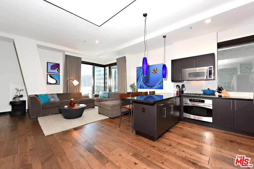 Stunning corner 2b/2b high-rise condo with dramatic floor to ceiling windows and panoramic views of Downtown Los Angeles from the 12th floor. This rare corner unit features nearly 1250sf of living space, tall 11-foot ceilings and upgraded hardwood floors throughout. Fully equipped with brand new Washer & Dryer, modern kitchen with stainless appliances and breakfast bar. Primary open plan bedroom area (or office) has large windows, an ensuite bathroom with dual sinks and a massive closet. Second bedroom is fully enclosed with a private bathroom and a large closet. There are custom roller shades as well as blackout curtains throughout the entire unit, and upgraded lighting. Includes 1 parking space in the building and a large private storage unit. City living at its finest with amenities including 24/7 staffed front desk, concierge service, gym, lounge/game room, and roof deck with BBQ, fire pit, and skyline views. Located in the heart of the Financial District of DTLA, within blocks of Whole Foods, 7th & Fig, The Bloc, LA Athletic Club, Hotel Figueroa, Wilshire Grand, Crypto Arena, FIDM, LA Live, Grand Central Market, The Broad, Walt Disney Concert Hall, The Conrad, Grand Park, and more. Rent includes water, trash, gas.