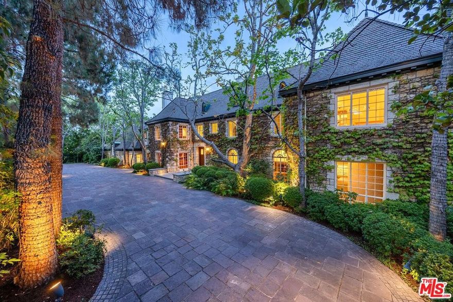 "The Jerry Moss Estate" - A most special offering in a most prestigious location. Over 3/4 of an acre in the heart of East Gate Bel Air. Classic English style with stone facade and steel windows throughout. Complete privacy behind mature landscape and large wrought iron gates. Large public rooms are excellent for entertaining on a grand scale. Over 11,000sqft. Substantial primary suite with dual baths, vast closets and an office. Exceptional in every sense and ready for next chapter. Shown only to prequalified buyers.