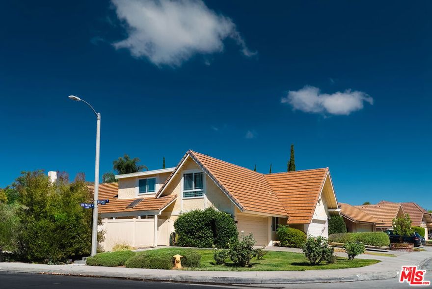 One of the largest corner lots in Valencia Racquet Club! Rare find with unmatched lot size and location. This stylish 4-bed, 2-bath home boasts an open layout filled with natural light, soaring ceilings, fresh paint, and smart lighting. A bright white kitchen with a large island, glass-front cabinets, and recessed lighting connects to dining and family spacesideal for hosting. French doors open to a private wraparound backyard featuring a brick patio and plenty of room to garden, play, or add a future pool. The primary suite on the main level includes an updated vanity and ample closets. Upstairs, a large versatile bedroom with two walk-in closets and designer wallpaper offers space for a guest retreat, office, or studio. Two additional bedrooms share a full bath. Extras include security cameras, an oversized 2-car garage.The community offers a pool, spa, sports court, and playground, with large public parks and top-rated schools just minutes away.