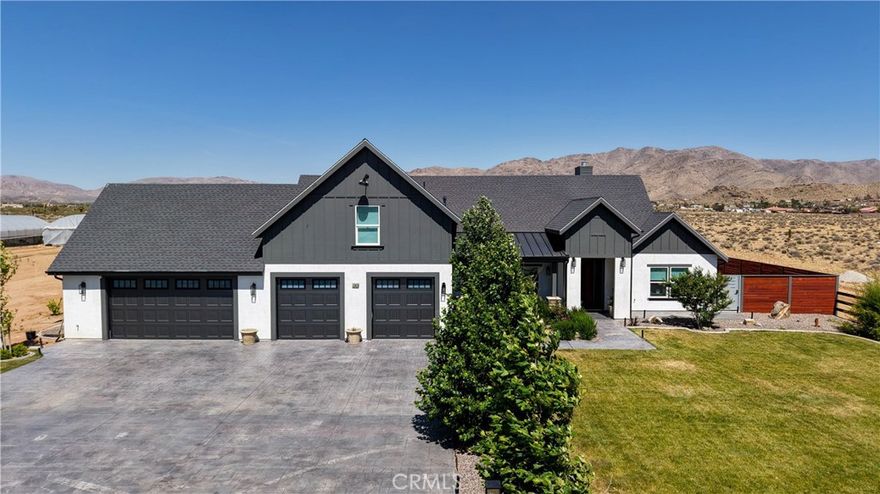 Welcome to your new home! Check out this AMAZING CUSTOM-BUILT HOME with an ADU!! This home was built in 2022. The ADU would be perfect for your mother-in-law, family or extra income.  This property has its own WELL so no more water bill. The main house has 4 bedrooms, 3 full bathrooms, 2901 sq ft. The kitchen is a chief's dream with a huge island, double oven, wine fridge, trash compactor, dishwasher, 6 burner stove top with grill, draw microwave and quartz counter tops. Kitchen appliances are the same brand, Jenn-Air. Home features real wood flooring throughout with carpet in the bedrooms. All bedrooms have custom accent walls. The dining room features wood beams and accent wall. The property has PAID OFF SOLAR. The main house has 4 car garage, so you have plenty for parking all of your cars and toys. The ADU is approximately 800 sq ft with 2 bedrooms, 1 bath, washer and dryer hook up and 1 car garage attached. ADU has its own driveway entrance. There is an additional structure approximately 40ft x 20 ft for barn horse house but can be converted to another ADU. The property sits on just under 2 acres with 2 greenhouses. The larger greenhouse is 100ft x 30ft and the smaller one is 30ft x20ft with drip system, fans and vegetables already growing. Come check out this house, you wouldn't regret it!