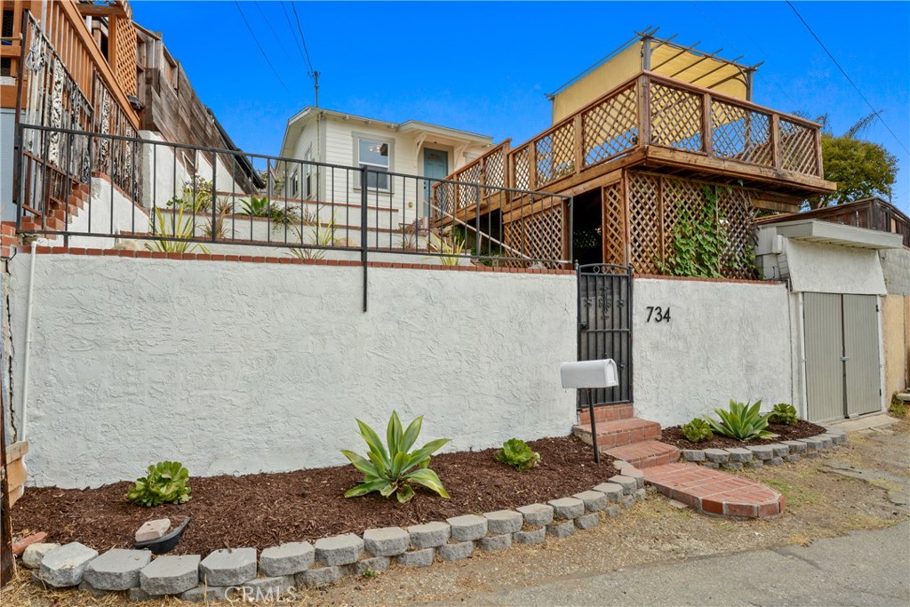 No… you’re not seeing things! This is a move-in ready SINGLE-FAMILY HOME in the South Bay under $500,000! Tucked away in a hidden pocket of homes (and NOT on a busy street), this charming 1920s Craftsman sits directly across from a neighborhood park and the Bandini Canyon Park entrance with its scenic walking trails. This home maintains much of its original charm while offering both infrastructure and cosmetic upgrades. Major upgrades include foundation improvements, a newer roof, dual-pane windows, fresh interior and exterior paint, and durable laminate and LVP flooring. A brand-new ¾ Jack-and-Jill bathroom features a walk-in shower, vanity, and stylish fixtures—everything is brand new! As you ascend the stairs to this cute home, you’ll find a terraced front yard with drought tolerant landscape and irrigation, and a spacious deck that provides space to entertain, or just sit and enjoy your morning coffee or a late summer barbecue! You’ll feel like the you’re on top of the world with the views of open space around you. Enter through the new front door with a leaded glass window into a bright living space. The kitchen has been reconfigured to allow for more counter and storage space, and has refinished butcher block countertops, a new sink, faucet and garbage disposal. The side-by-side laundry area (washer and dryer included!) sits just off the kitchen. Spend cozy evenings lounging in the spacious living room which leads to a private terraced backyard anchored by a fragrant plumeria tree. Additional highlights include a street-level one-car garage, new water heater, updated light fixtures, fresh hardware throughout, and more. This is the perfect condo alternative—no HOA fees, plenty of privacy, and all the charm of a starter home with room to grow. Don’t miss your chance to make it yours!