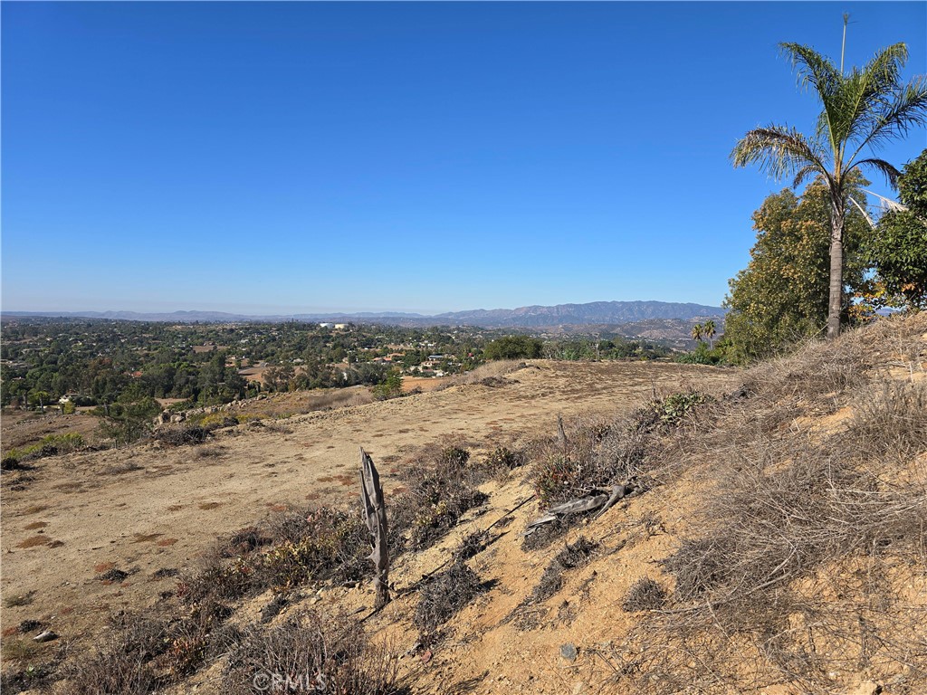 Premier 6-acre property to build a home and ADU in North San Diego County. AMAZING VIEWS!!! This is part of an exclusive, private, gated, mountaintop area of Fallbrook. The pad is ready for your dream home. This property has some of the best views in all of Fallbrook. Water and Septic are already installed on the property and electric nearby. Ocean views on a clear day with views from Sleeping Indian, Oceanside, Fallbrook, Palomar Mountain, Vista and Escondido. Very private exclusive community with a 300 degree view of the surrounding vista's, ocean line and city lights. Already has an existing large pad area and previous approved plans to build. Private estate properties of 3,000 to 10,000 plus sq-ft of seven custom homes. Private road. One of a kind property.