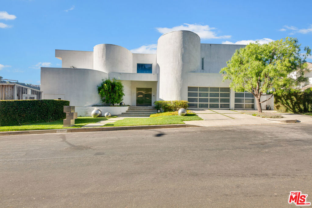 Welcome to this exquisite custom A.I.A. award-winning home in the prestigious Royal Oaks neighborhood of Encino, south of Ventura Blvd. This modern contemporary masterpiece offers a luxurious and spacious living experience, featuring 4 bedrooms and 4.5 bathrooms. As you enter, you'll be greeted by an abundance of natural light streaming through a massive wall of windows, providing stunning views of green hills and distant Valley lights. The property contains an impressive 4,575 square feet of living space, with ample room for relaxation and entertainment. The three-car garage ensures convenient parking for your vehicles. Step outside and be captivated by the allure of the beautiful black bottom pool with a 75-foot lap lane, perfect for staying active or simply unwinding under the California sun. The expansive 20,198 square foot lot allows for various outdoor activities and landscaping possibilities. One of the most striking features of this home is the unobstructed views of the Valley lights, offering a mesmerizing panorama that will leave you in awe every night. The primary bedroom is a true retreat, with two large walk-in closets and two luxurious bathrooms boasting Bulthaup cabinetry, natural stone counters, and extensive custom floor and wall tile. The adjoining spa-like marble wrapped steam shower completes the master suite, providing a serene and indulgent experience. Three of the bedrooms are adorned with elegant custom Limestone Giordano Italian wood doors, adding sophistication and comfort to these living spaces. For added security and peace of mind, all accessible windows and sliding glass doors are equipped with Campbell Security anti-theft "Riot Glass" and security screens. Welcome guests through the grand custom Neoport stainless steel doors which set the stage for the contemporary elegance found throughout the home. Enjoy cozy evenings with two fireplaces, one nestled in the master bedroom and the other in the living room. The airy and open design of the home showcases 10 and 12 foot ceilings throughout and double height ceilings in the entry foyer and great room. The kitchen is a chef's dream, equipped with a Subzero built-in fridge and a suite of stainless steel appliances. Outside, you'll find a separate structure that can be used as a workshop or home office, providing a private and productive space away from the main living areas. The backyard features artificial grass, ensuring low-maintenance and drought-tolerant convenience, allowing you to enjoy the outdoor space without the hassle of constant upkeep. This meticulously-maintained property has a number of notable upgrades. The roof was replaced in June 2023, both primary bathrooms were extensively remodeled in 2019, the pool was completely refurbished and all the pool equipment was replaced in 2021, the HVAC systems have been continuously upgraded, and a Noritz tankless water heater and LifeSource whole home water filtration system are recent additions. This modern architectural home in the Royal Oaks neighborhood of Encino epitomizes contemporary luxury, featuring thoughtful design and premium amenities catering to the most discerning tastes.