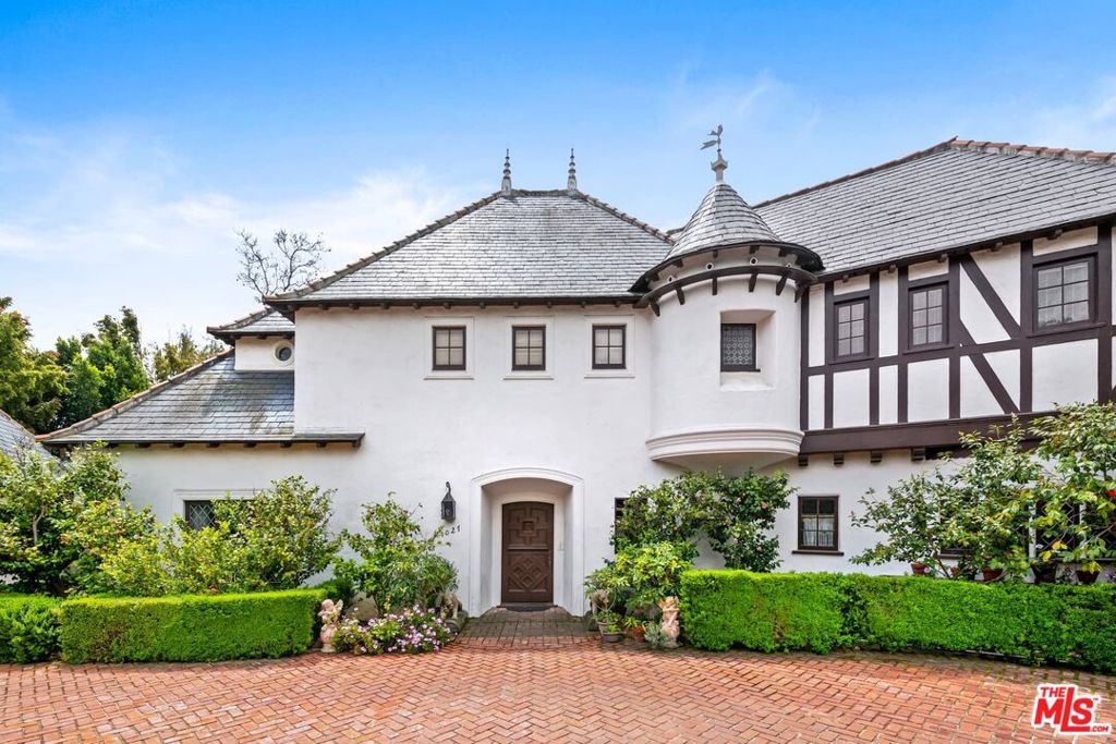 A rare offering, Maison Lucile is an iconic French Norman-Eclectic Revival estate nestled in a bucolic setting on a coveted cul-de-sac along star-studded Ridgedale Drive. On a street known for its legendary entertainment industry cachet, the property presents as one of the best preservation and restoration opportunities to come to market in Beverly Hills. Designed by architect Nicholas A. Kabush in 1935, the exquisite residence retains an excellent level of original historic integrity and detail.The compound features four bedrooms, four bathrooms, an expansive pool, and verdant gardens on a prime .6-acre lot in one of Beverly Hills' most exclusive neighborhoods. The timeless exterior boasts a steeply pitched slate-clad roof with steeple-like finials, round towers with conical roofs, decorative half-timbering, distinctive stonework, leaded glass windows, and the original whimsical bird weathervane. A detached garage with parking for three cars and a gated circular drive complements the home's asymmetrical faade. Additionally, there is a lower level with a sitting room, bedroom, private bath, and separate entrance.Prominent early 20th-century California landscape architect Edward Huntsman-Trout was brought in to create the picturesque landscape design. His work at the estate reflects his penchant for mixing European classical garden design with California-style plantings. The home beautifully integrates with the surrounding landscape, with most of Huntsman-Trout's original design remaining intact. Meandering boxwood-lined pathways provide picturesque views and vistas throughout the garden, leading to a tranquil destination pool.On the border between Beverly Hills and Holmby Hills this street-to-street lot compound, with access from Ridgedale and Hanover, is surrounded by $30M-$60+M estates. Embodying Old-World style, Maison Lucile's unparalleled location and historic architectural design combine to create the ultimate opportunity to preserve and restore this iconic estate. Shown to pre-qualified buyers only.