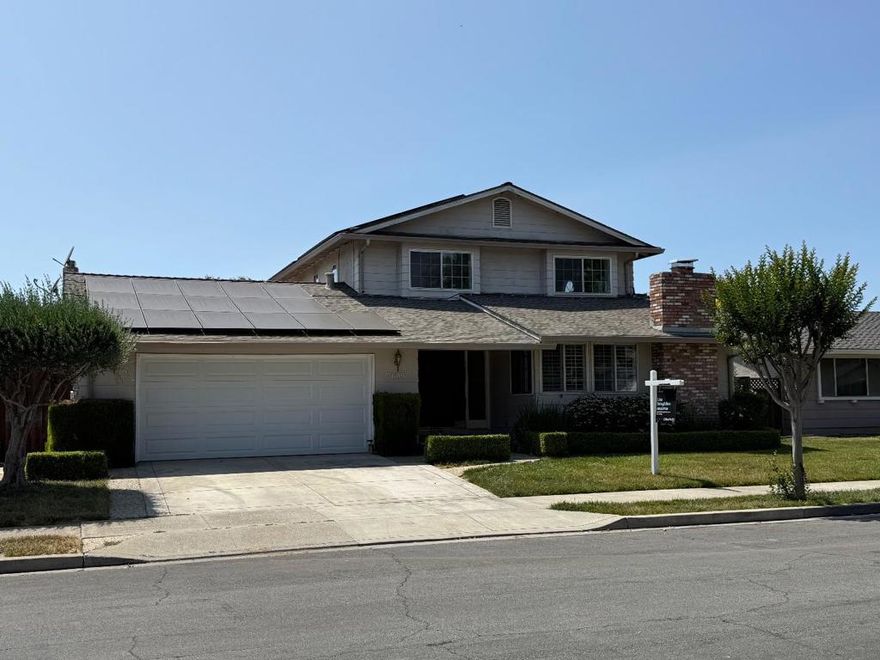 Welcome to this spacious 5-bedroom, 3-bath home nestled in a desirable Gilroy neighborhood. Situated on a 7,140 sq ft lot, this 3,015 sq ft residence offers a functional layout with a blend of original charm and modern updates. Featuring two primary suites, one on the main level, ideal for guests or multi-generational living, and another upstairs with a private balcony and hillside views. The inviting step-down living room boasts vaulted, beamed ceilings, while the family room flows into the kitchen for easy everyday living. A formal dining room adds elegance for entertaining. Recent improvements include fresh interior paint, a new gas stovetop in the kitchen, a brand-new garage door, and durable laminate flooring throughout. Enjoy the private backyard with a pool, perfect for summer fun and relaxation. With its flexible floor plan, scenic touches, and thoughtful upgrades, this home is a must-see opportunity in a well-established Gilroy community.