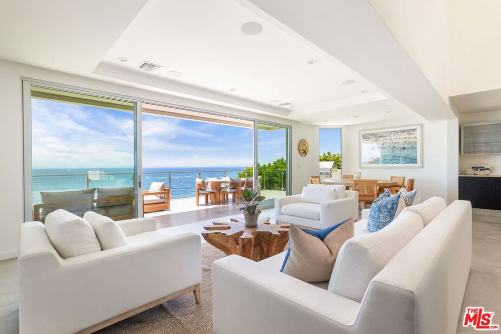 Located on the exclusive bluffs of Broad Beach, along one of Malibu's most prestigious enclaves, this modern home captures the perfect blend of luxury living and coastal romance. Breathtaking views of the Pacific Ocean and Point Dume stretch almost endlessly beyond the walls of glass and expansive decks, while the soundtrack of the waves are constant, serene and soothing. Polished wood, clean lines, and natural stone create a sense of calm sophistication. Custom smart home system for comfort and security. Detached guest house. Manicured garden. Gated. Incredibly private.