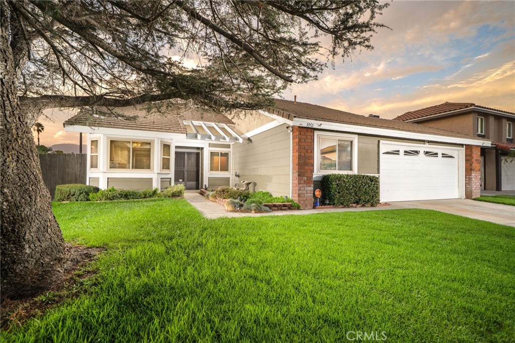 CHARMING SINGLE STORY HOME IN COVETED CREEKSIDE. Beautifully maintained single-story home in one of Ontario’s most inviting neighborhoods. Offering 4 bedrooms, 2 bathrooms, and approximately 1,476 square feet of living space, this residence combines comfort, functionality, and lifestyle appeal inside and out. Step inside to a bright, open layout featuring wood laminate flooring, neutral tones, and a spacious living room anchored by a cozy brick fireplace. Large sliding glass door leads directly to the backyard, creating seamless indoor-outdoor living. It also allows natural light to fill the living space. The galley-style kitchen is well laid out and features crown molding, recessed lighting, ample cabinetry, and a charming bay window dining nook that fills the space with natural light. The primary suite offers a peaceful retreat with backyard access, mirrored closets, and an en-suite bathroom complete with dual sinks and a walk-in shower. Three additional bedrooms and a full hall bath provide flexibility for family, guests, or a home office. Outdoors, the backyard is designed for both entertaining and relaxation. Enjoy California evenings under string lights, cookouts with a built-in gas line for your BBQ, and the bounty of multiple fruit trees including tangerine, orange, persimmon, kumquat, and lemon. Raised planters, low-maintenance landscaping, and a storage shed add both charm and functionality. There is even potential for additional parking or storage on the side paved area. Additional highlights include an attached two-car garage and a location within a well-kept HOA community with modest dues of $79/month. Recent updates further elevate this home’s value: recent paint interior and exterior, new AC compressor (2023), wood laminate flooring (2020), whole house fan (2020), dual-pane windows (2014), and a 12 kW Generac generator for reliable back-up power.