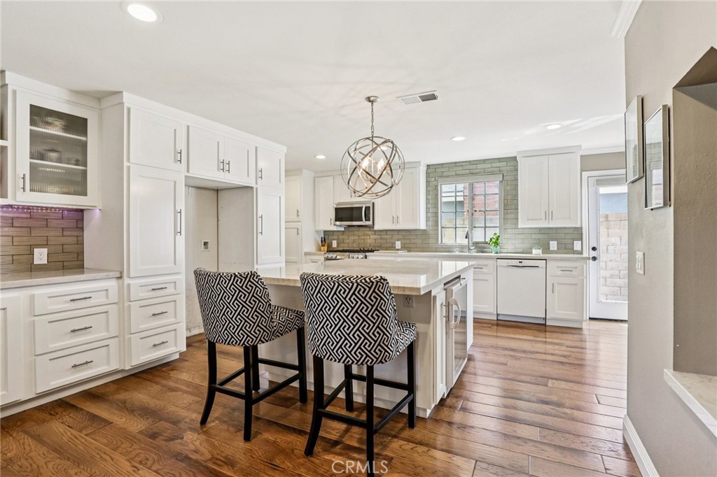 Executive 5-bedroom, 3-bath home offering 2,020 sq. ft. of living space on a flat, private 7,245 sq. ft. lot. The main floor features a spacious primary suite with bath, two additional bedrooms, a hall bath, and beautifully refinished hardwood floors. The remodeled kitchen and baths showcase modern finishes and upgraded recessed lighting, complemented by newer vinyl windows and doors throughout.
Upstairs, two permitted bedrooms and a full bath provide flexibility for guests, or home office. The expansive backyard features lush grass, mature trees, and shrubs—ideal for entertaining or relaxing outdoors.
With thoughtful design, quality upgrades, and no HOA restrictions, this move-in ready home stands out. Come see it today!