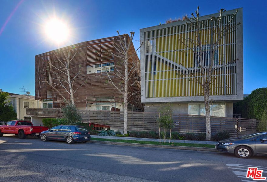 This architectural loft is located a block away from Los Angeles's coveted Beverly Blvd. and puts you tight in the heart of one of the most vibrant neighborhoods in Los Angeles. Nestled on a NY style residential street you are moments away from the posh amenities of Beverly Hills; quaint shopping & fine dining along Beverly Blvd; the nightlife along the World Famous Sunset Strip and mind blowing exhibits at the Los Angeles County Museums of Art. There is no shortage of venues to explore - this is not just a place to call home but a community to join & explore. This dramatic corner-unit was designed by Pugh + Scarpan, AIA who have captured the synergy between glass, steel and cement to create an inspiring living experience featuring 20 foot ceilings, a floating fireplace, custom stained concrete floors with room for an in-home studio, office or guest room. Incredible wall space for your art collection, a gourmet kitchen fitted with Jen AIR appliances and granite counters. Upstairs main bedroom with wide plank wood flooring, walk in shower and soaking tub. Secure gated parking and dedicated storage. Very quiet location and will not last.