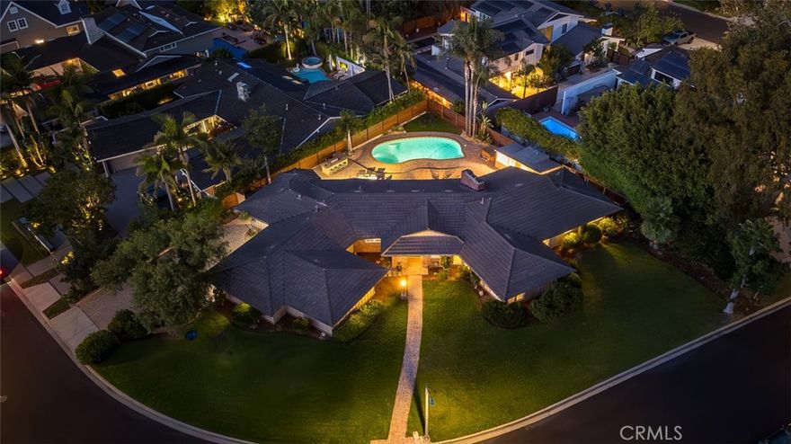 Experience the art of elevated California living at 1430 La Perla Avenue, an exquisite single story retreat in the exclusive Estate Section of Park Estates. Perfectly situated along one of Long Beach’s most admired, tree lined avenues, this residence captures the essence of refined California living, warm, private, and effortlessly connected to the outdoors. Resting on an expansive lot of over 13,000 square feet, the home spans approximately 2,900 square feet and offers four generous bedrooms, four bathrooms, and one flexible bonus room. The open and sunlit layout encourages a natural flow between spaces, with large picture windows framing tranquil views of the terraced backyard. The spacious family room serves as the heart of the home, featuring vaulted, beamed ceilings and a wall of glass that draws the outdoors in. Formal and casual dining areas provide comfortable options for entertaining or quiet evenings at home. Outside, a true Southern California oasis awaits, complete with a sparkling pool and spa, built-in barbecue, dining patio, and lush landscaping that invites both relaxation and celebration. Just beyond the pool, a detached pool house includes a convenient pass through wet bar, shower, and lounge, ideal for weekend gatherings or visiting guests. The kitchen is beautifully appointed with Thermador appliances, new granite counters, and plentiful storage, while the reimagined primary suite offers a spa-like bath with a steam shower and custom walk-in closet. Additional highlights include newly installed oak flooring, a newer roof, and stylish finishes throughout. A driveway framed by mature trees leads to a three car garage with built-in workshop space. One wing of the home offers a separate entrance, providing privacy and flexibility for guests, a home office, or an artist’s retreat. Opportunities to own a property of this caliber are rare, an elegant estate that embodies space, serenity, and the timeless charm of Long Beach’s most coveted neighborhood.