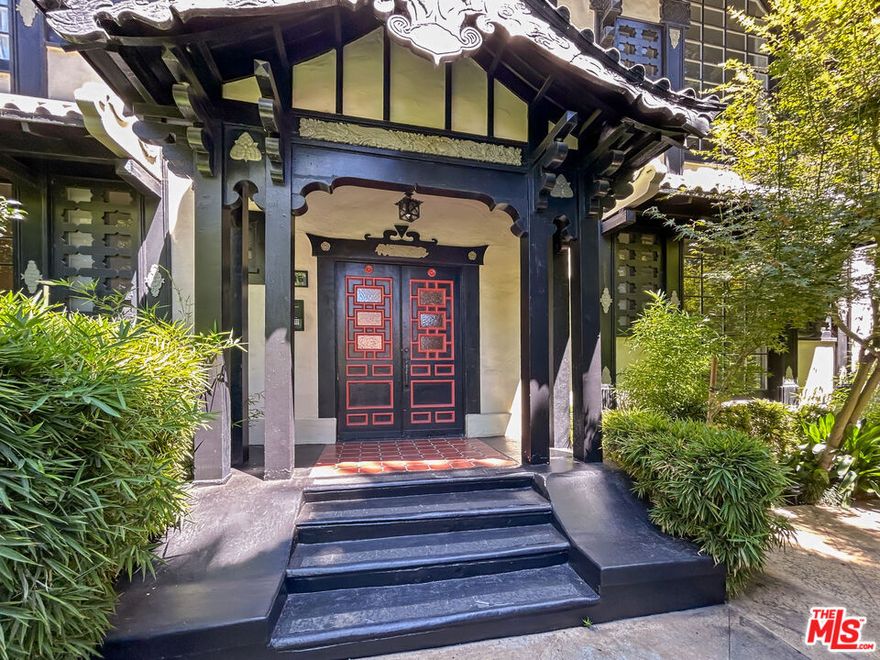 Extra-large one-bedroom residence with bonus den, offering the rare opportunity to live in vintage architectural splendor at the historic Lotus Apartments, designed in 1928 by architect William Hauptman. This distinctive Far East-inspired building is a true West Hollywood treasure, showcasing original design elements including decorative banding, corbels, metal cresting, peaked and undulating gables, wood window grilles, large arched picture windows, hand-finished plaster, antique lanterns, and intricate Japanese relief insets. Nestled behind lush greenery, the property transports you away from the city's bustle while sitting just moments from the most vibrant stretch of the Sunset Strip. Unit F2 features soaring ceilings, brand-new floors, oversized garden-facing windows that flood the space with natural light, walk-in closets, modern fixtures, stainless steel appliances, and an in-unit washer/dryer, all while preserving the timeless charm of the building's original character. Secured parking included. The bonus room is ideal for a home office, gym, or media space. A rare opportunity to experience historic elegance with contemporary comfort in one of Los Angeles's most iconic architectural gems.