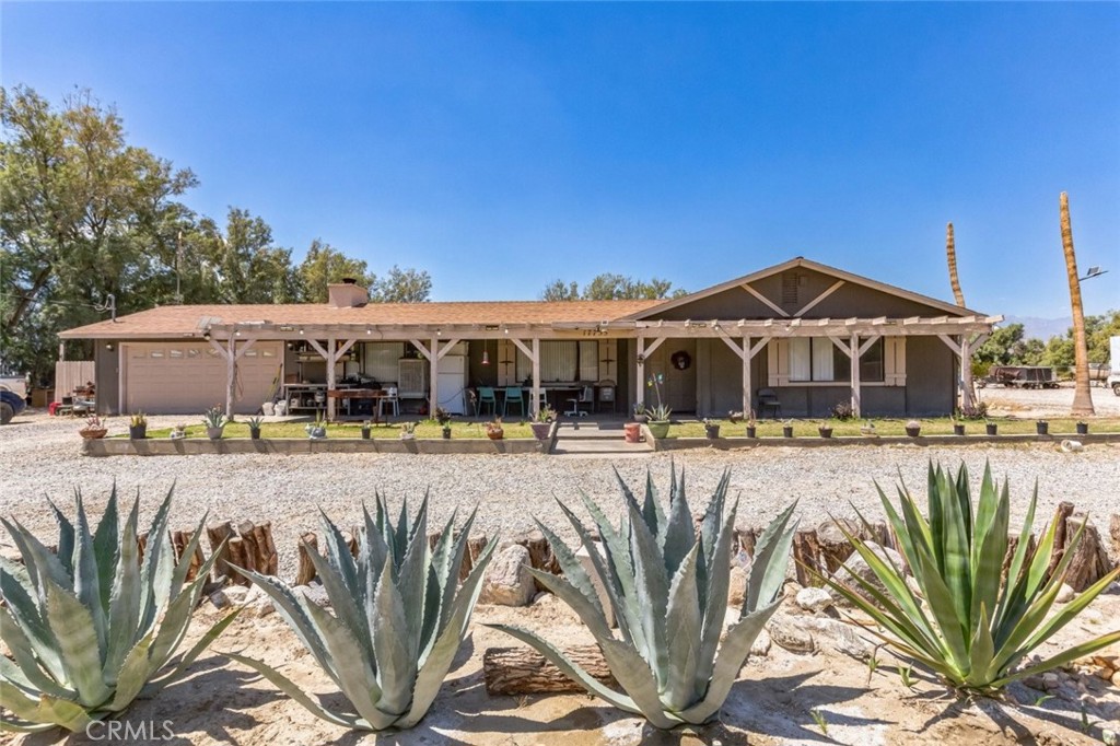 Nestled on nearly 5 acres in Desert Hot Springs, this private and distinctive gated ranch offers a unique living experience. The single-story home spans 2,678 square feet and includes 3 bedrooms and 2 bathrooms. Inside, you'll find tile flooring, ceiling fans with lighting, and ample storage throughout. The living room boasts a cozy fireplace, and the home also features a dining room, den, and laundry room. The kitchen is designed with granite countertops and equipped with stainless steel appliances. The bright and spacious bedrooms provide a comfortable retreat. The property includes an expansive exterior with an approximately 2,000 square-foot barn featuring 8 stalls, a tack room, and feed storage. Additionally, there is plenty of usable land. The property is zoned W, and the spacious driveway leads to a 2-car attached garage with ample additional parking. This ranch enjoys a great location near Desert Dunes Golf Course and overlooks the scenic San Jacinto Mountains.